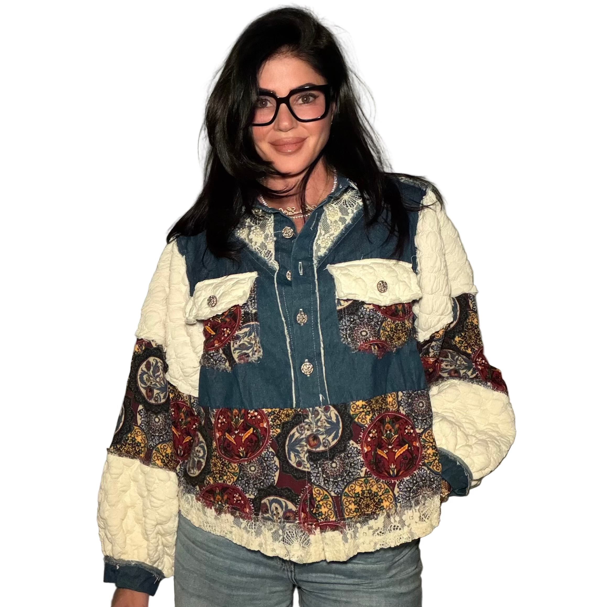 Person wearing a patchwork jacket with a neutral background