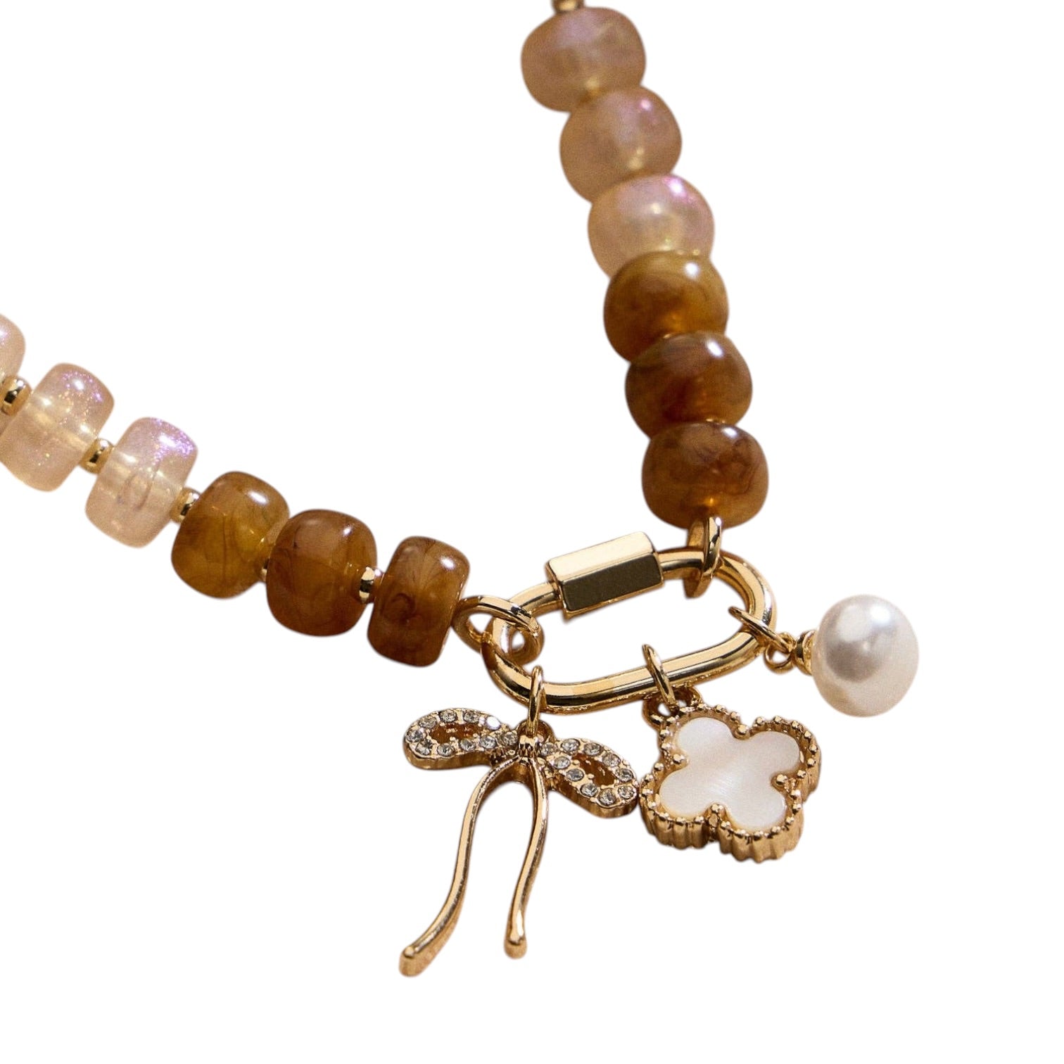 Bracelet with brown beads, gold charm, and pearl accent on a white background