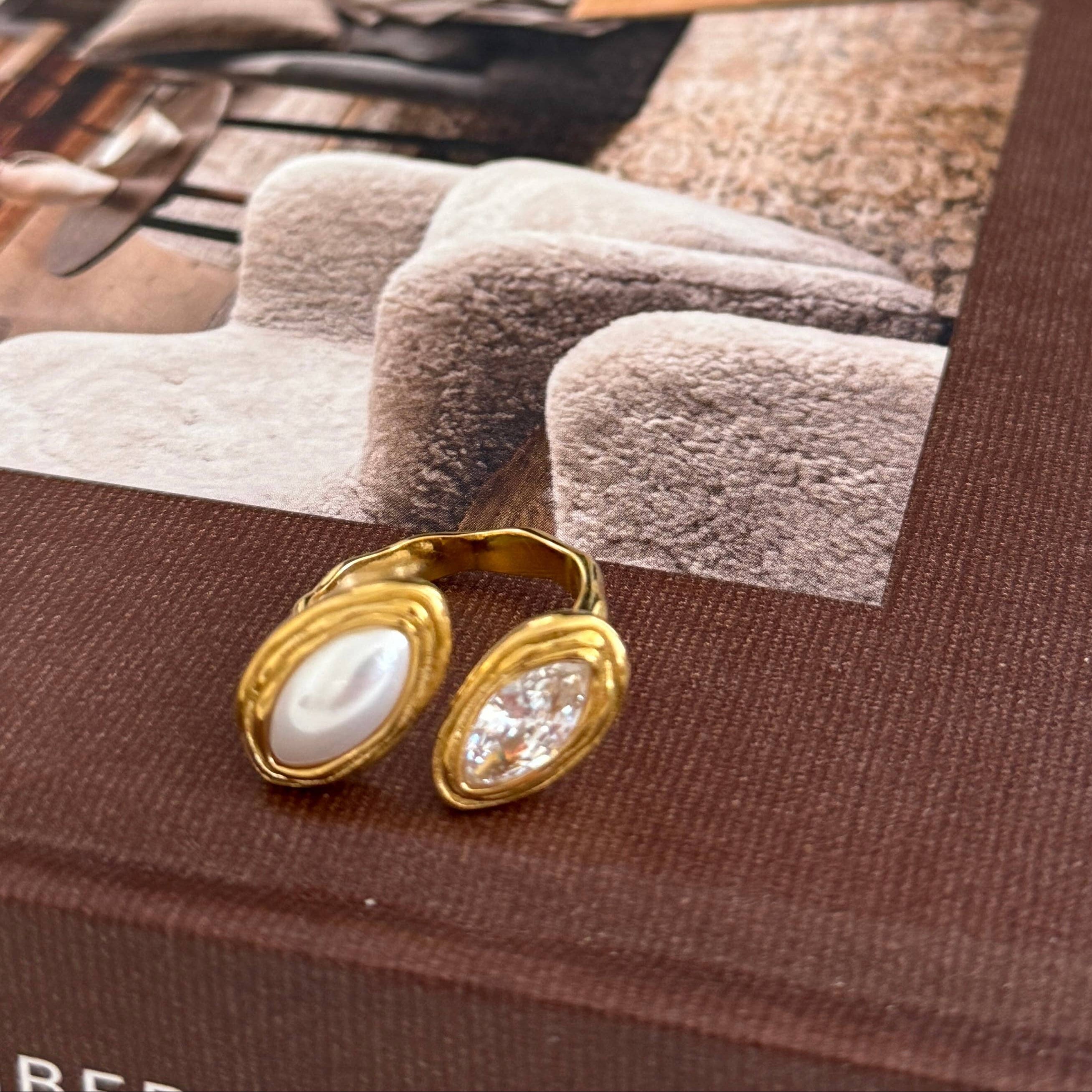 Gold earrings on a book