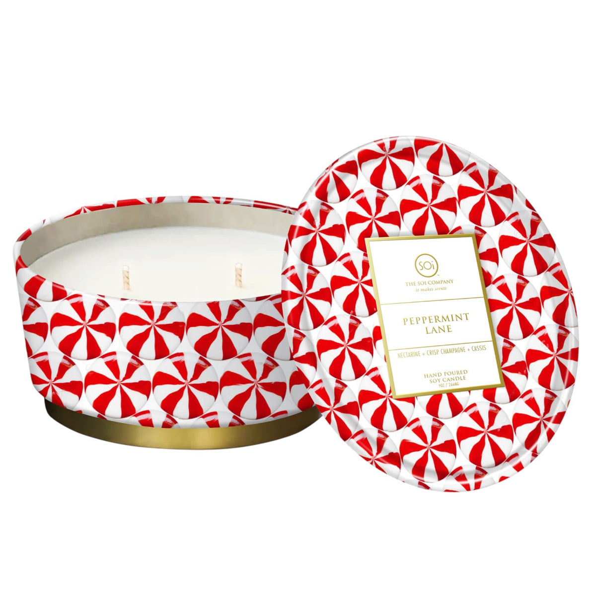 A round wax candle in a patterned tin with its lid leaning against the open container. The tin has a red and white candy cane motif and a gold band at the base.