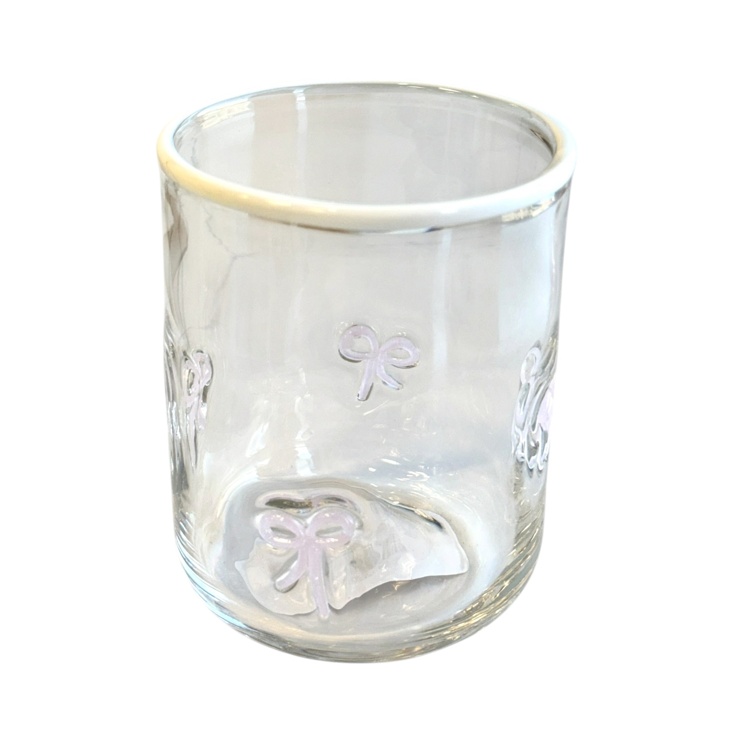Clear glass tumbler with embossed designs on a white background