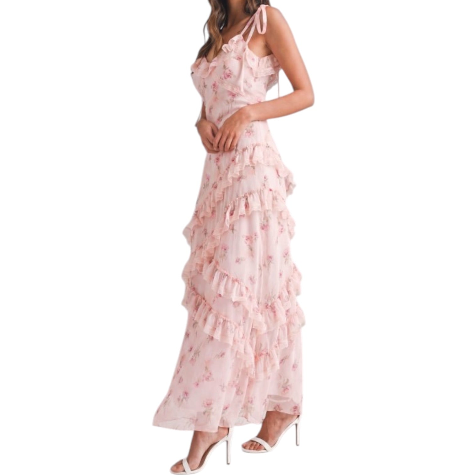 a woman wearing a pink floral dress with ruffles on white background