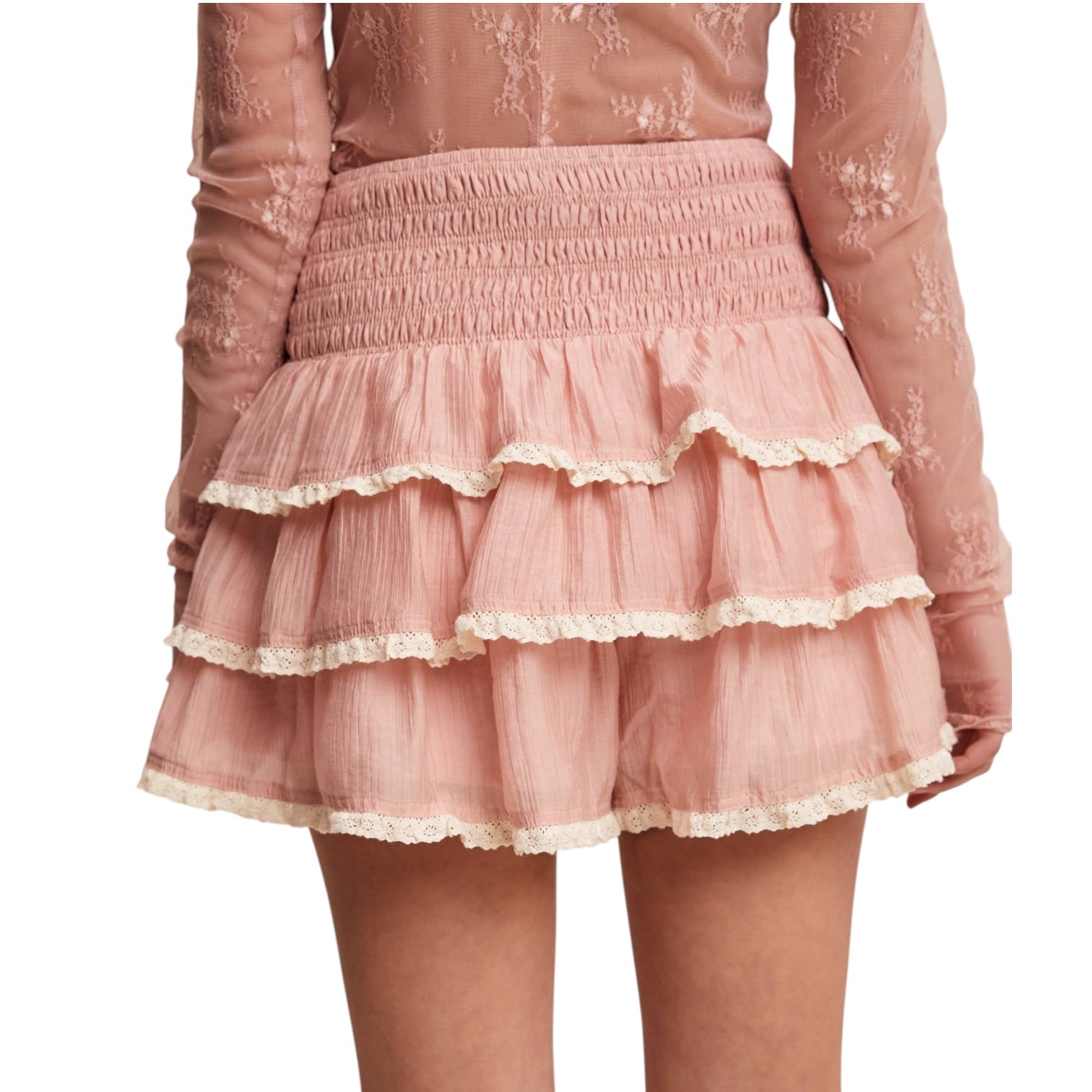 Pink lace with a tiered skort on a white background