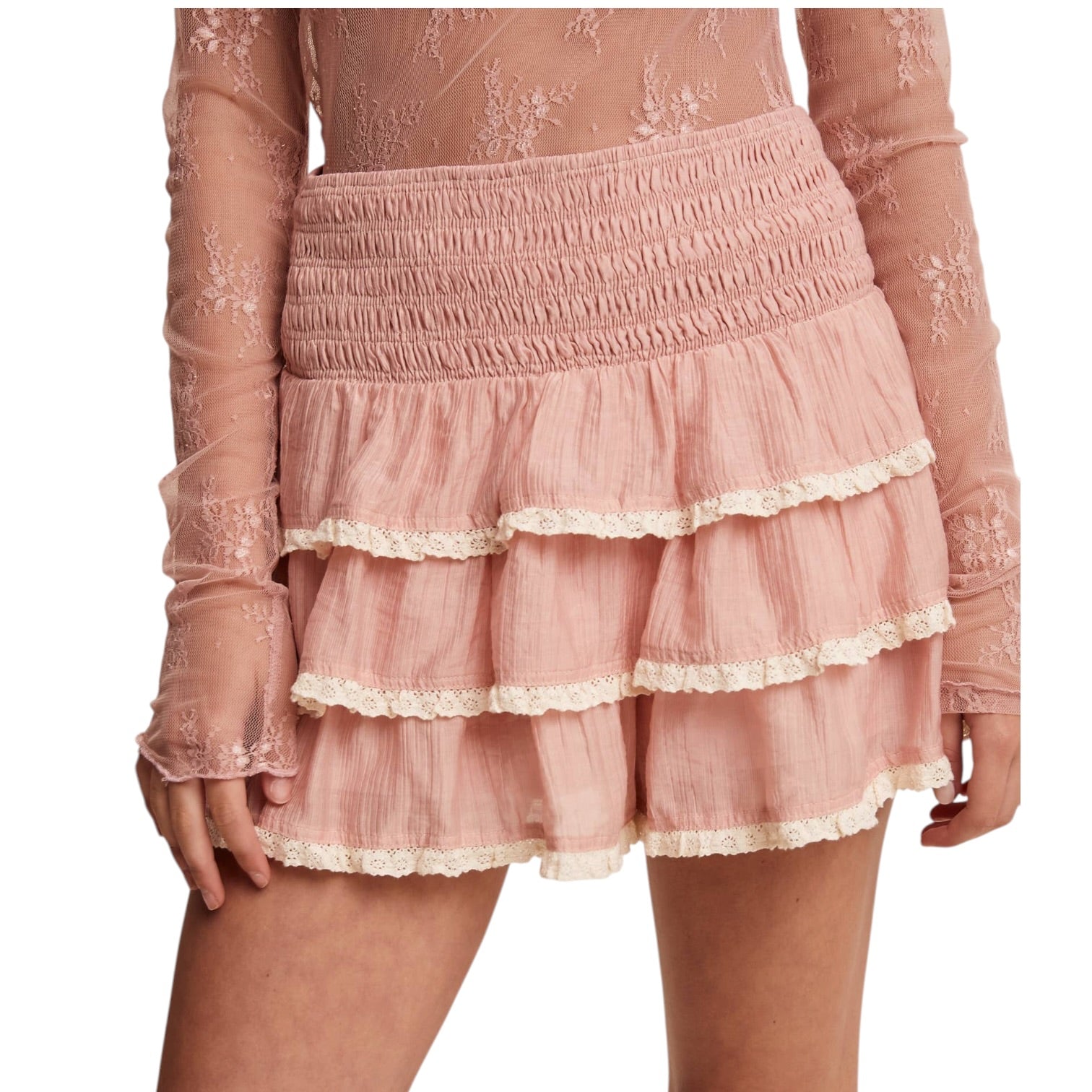 Pink lace skort with sheer sleeves on a white background