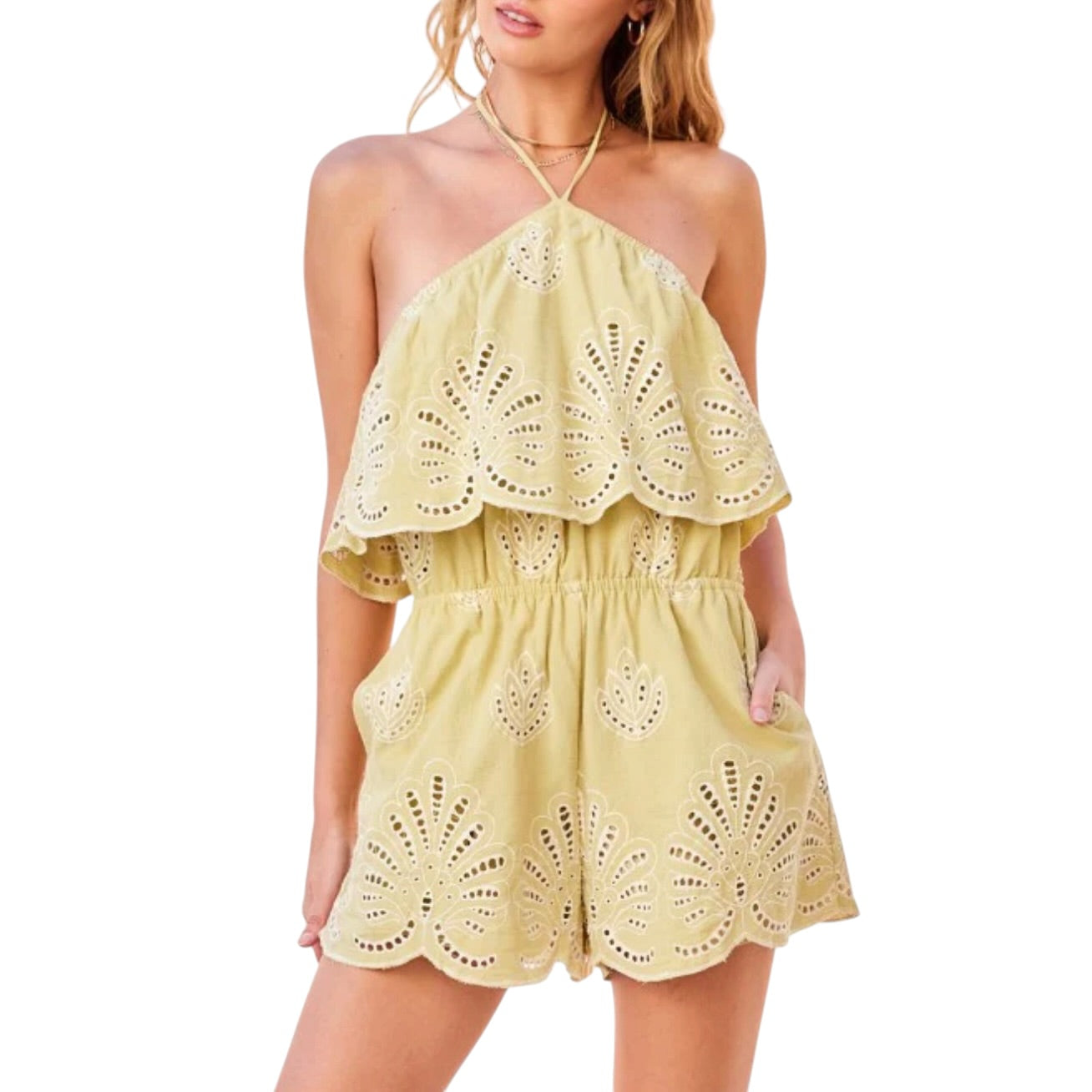 Pistachio lace romper worn by a model on a white background