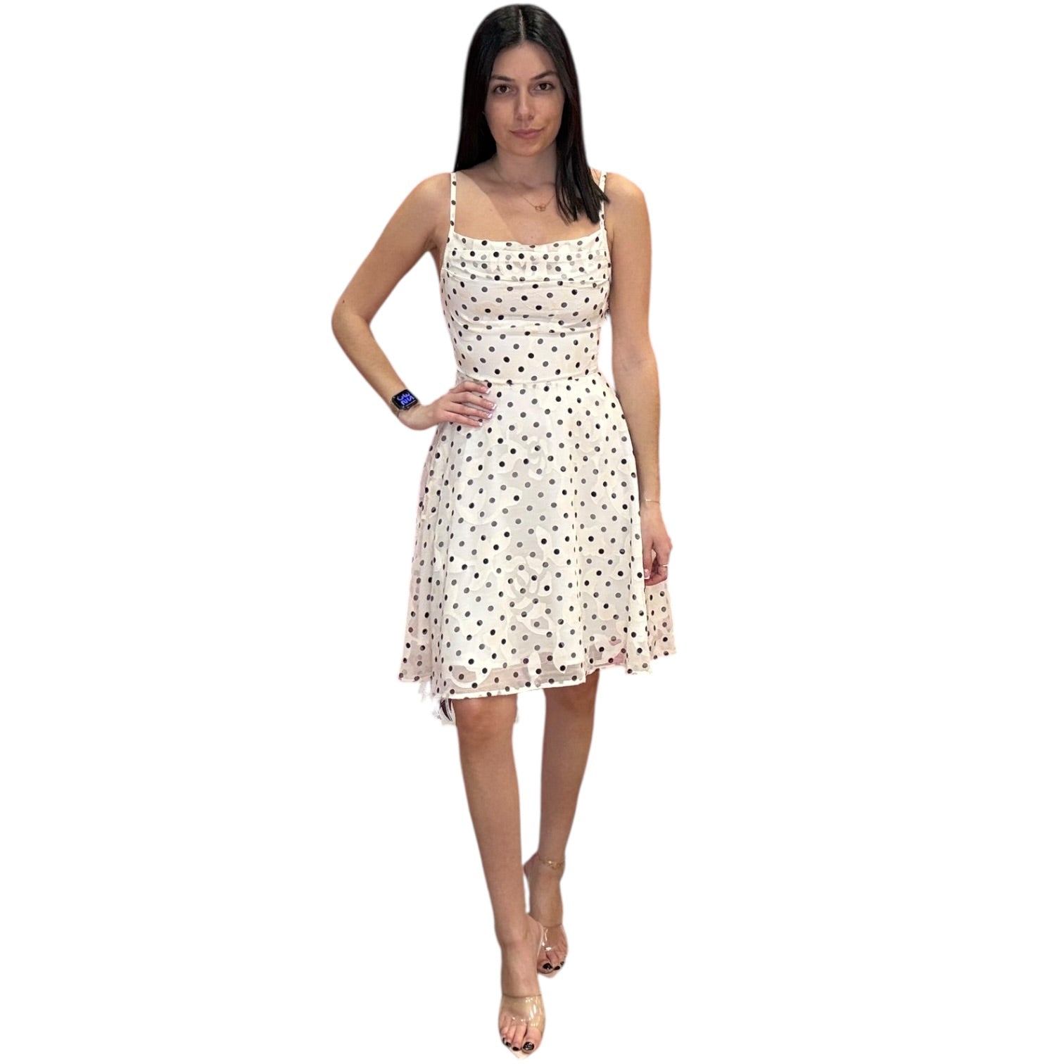 Woman wearing a polka dot dress on a white background