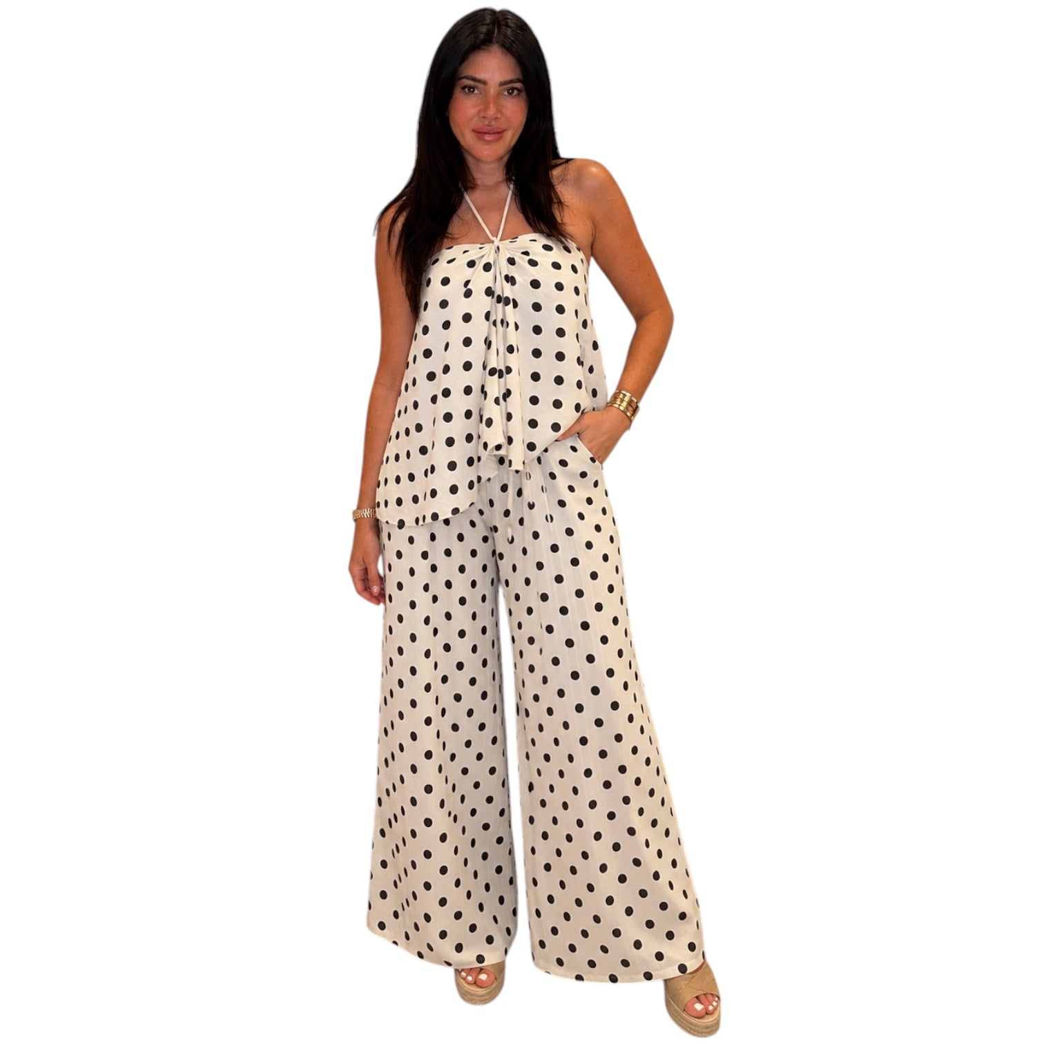 Woman wearing a polka dot jumpsuit on a white background