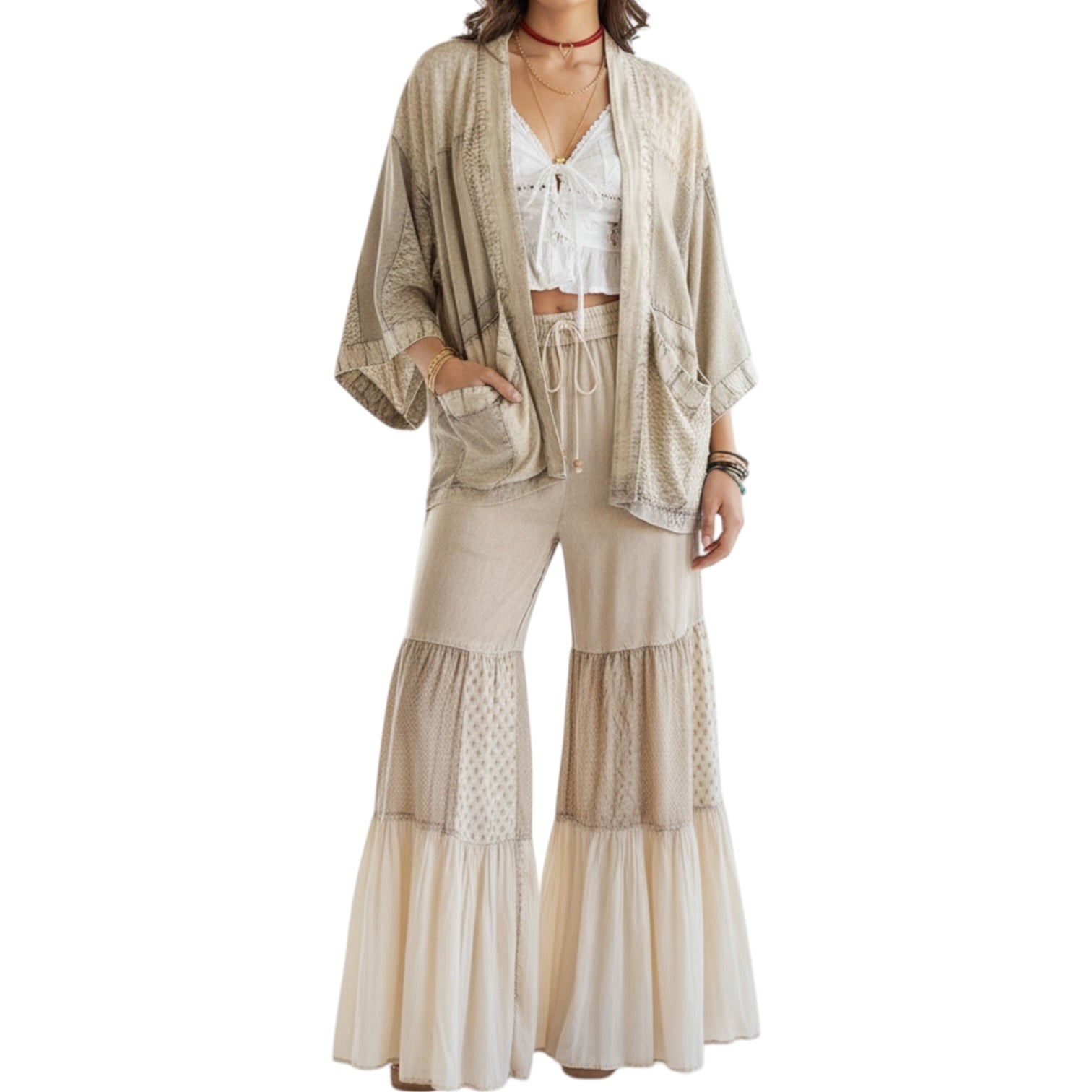 Woman wearing a beige kimono-style jacket and wide-leg pants on a white background