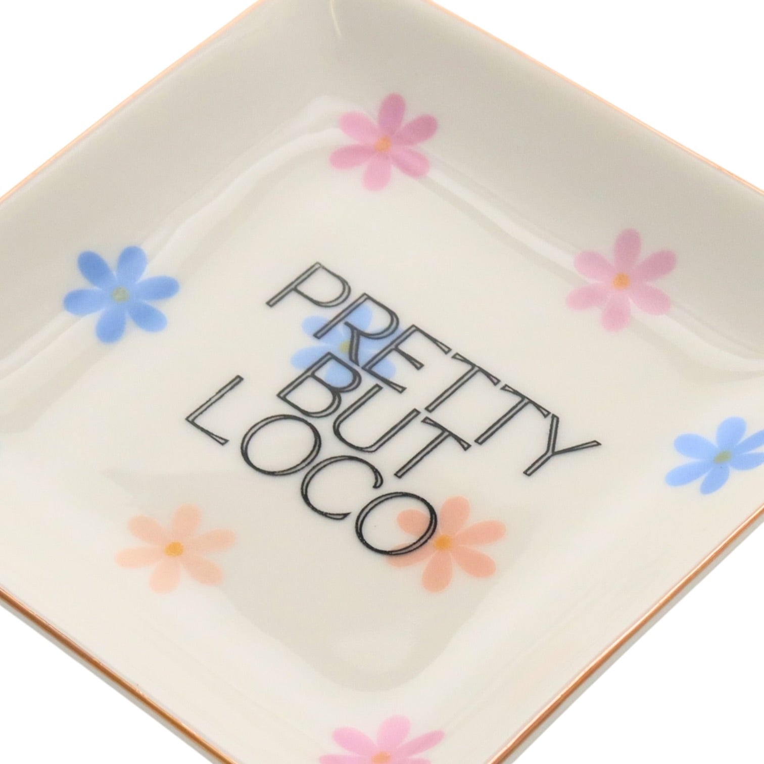 Square ceramic plate with 'Pretty But Loco' text and colorful flowers on a white background