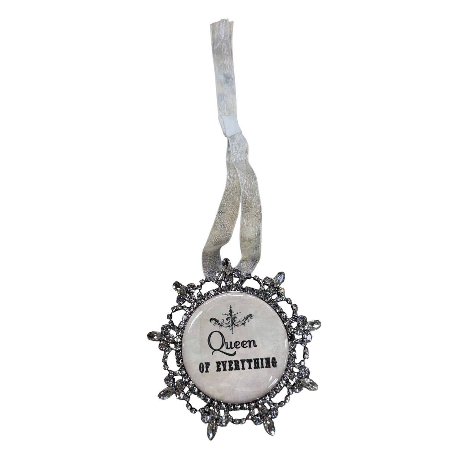 A gothic-style Christmas ornament featuring a circular cabochon with the text 'Queen of Everything' in black script, surrounded by an ornate silver filigree frame and a distressed silver hanging ribbon.