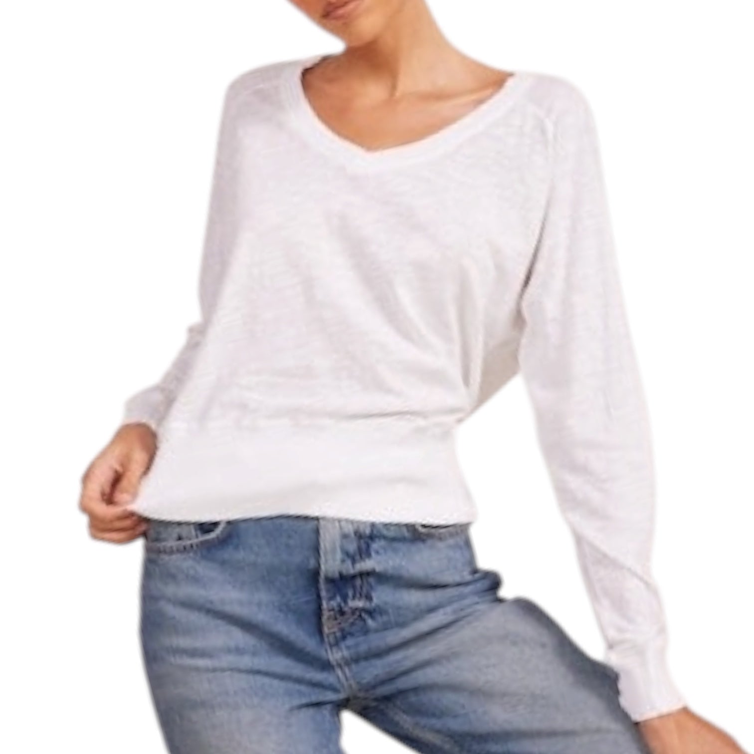 Person wearing a white long-sleeve top and blue jeans on a white background