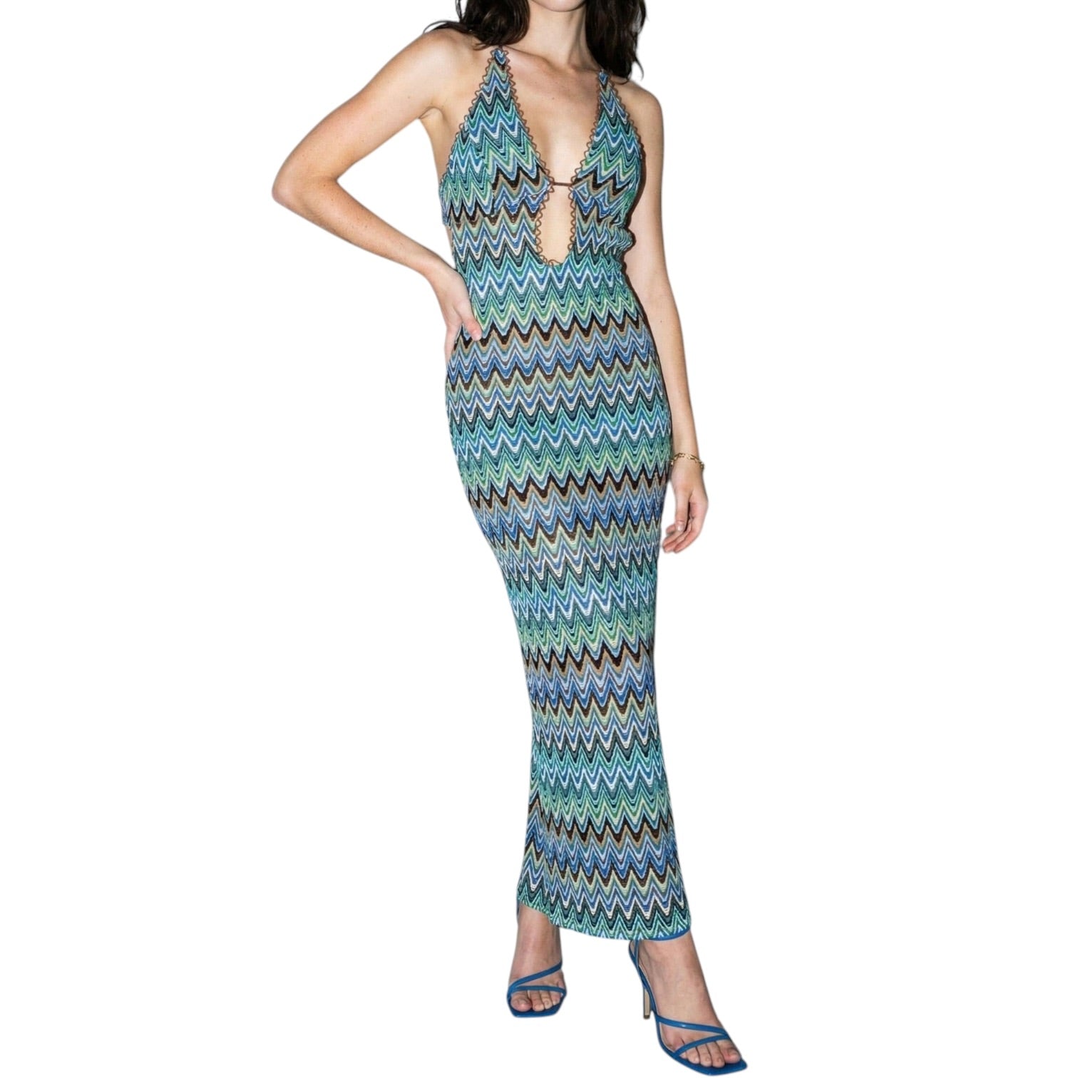 Woman wearing a patterned dress on a white background