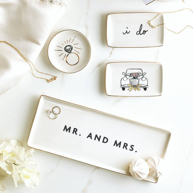 Set of decorative trinket dishes with 'i do', 'Mr. and Mrs.', and car illustrations on a white surface.