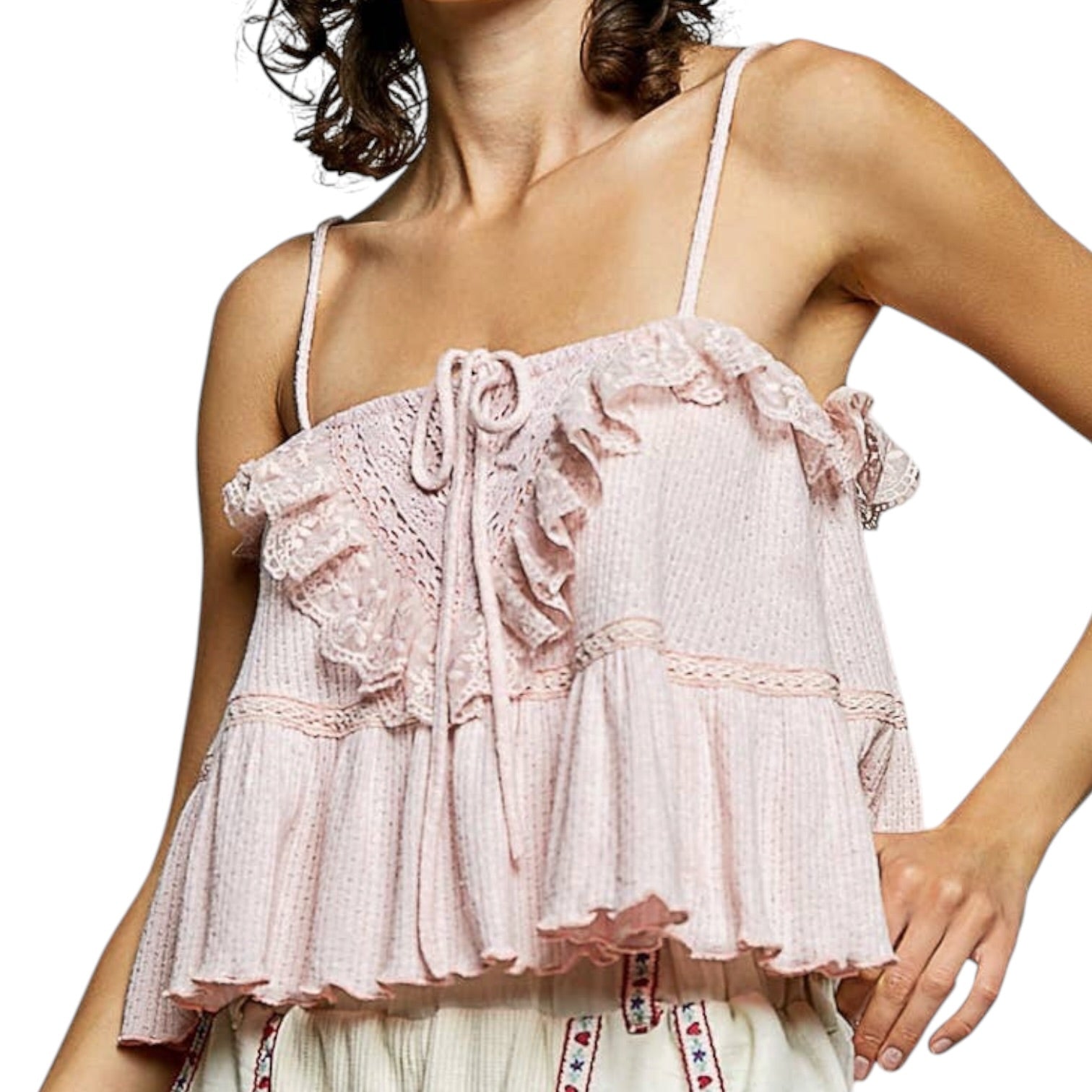 Light pink lace top worn by a person on a white background