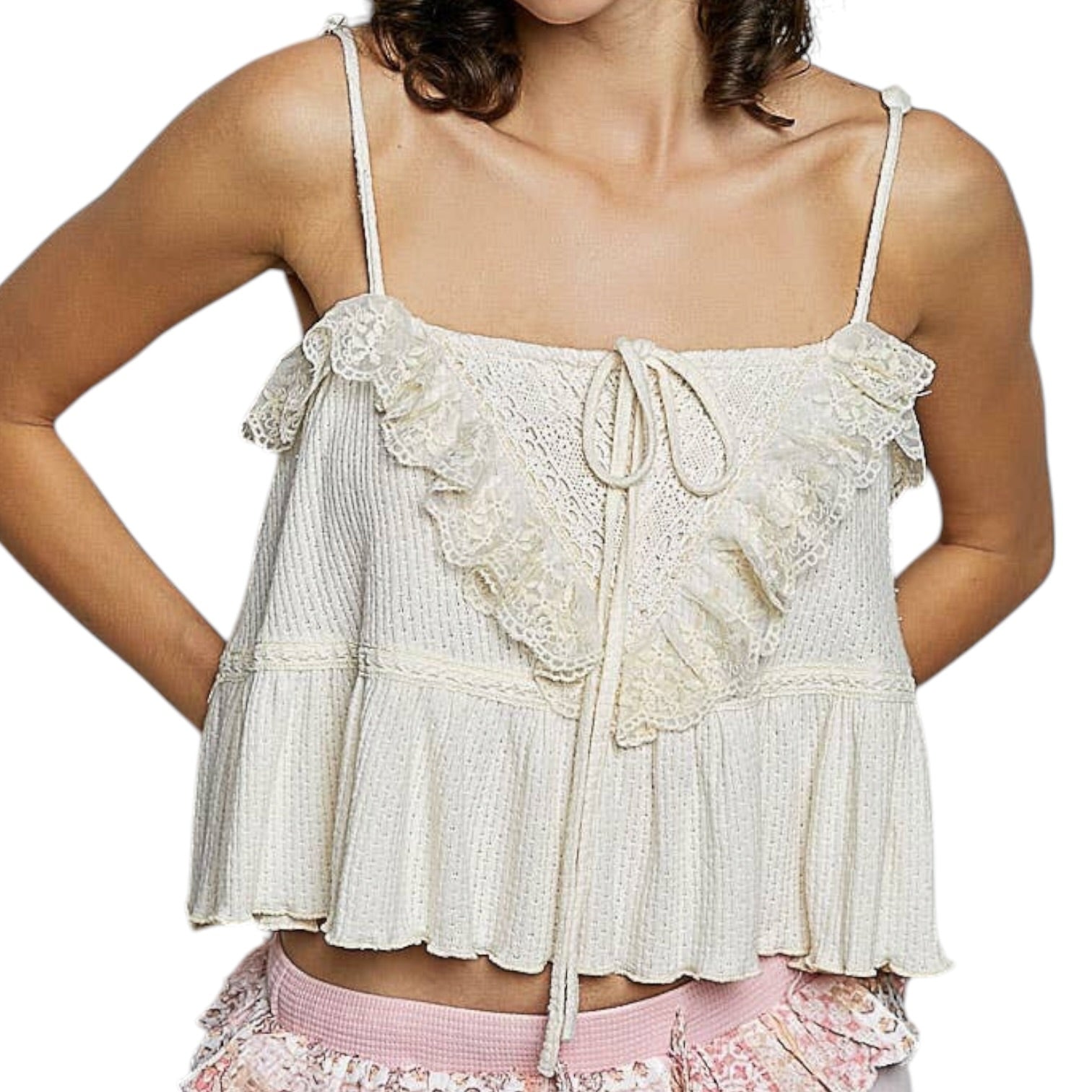 cream lace top with ruffled details on a white background
