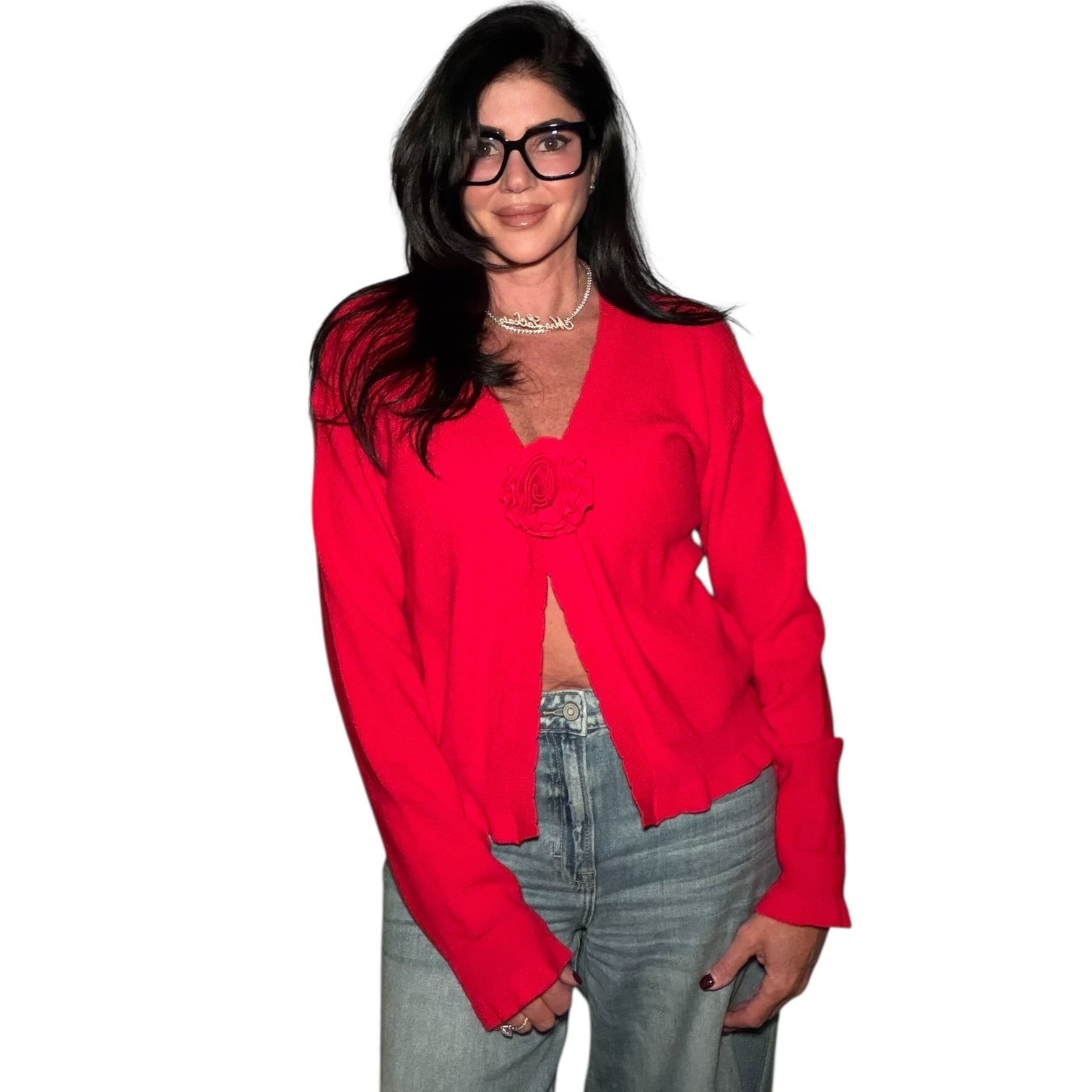 Woman wearing a red blouse and jeans on a white background