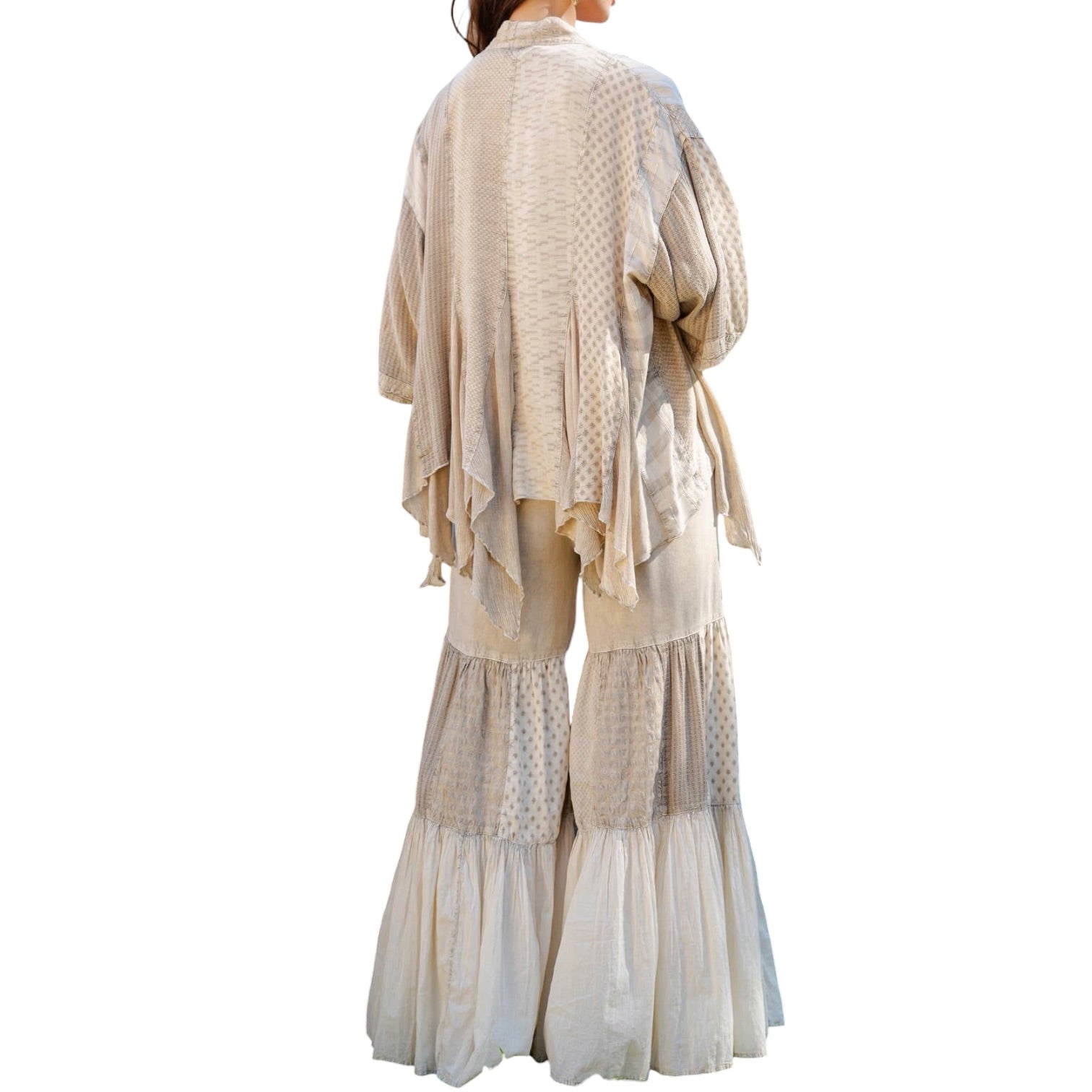 Beige layered outfit with a patterned top and wide-leg pants on a white background