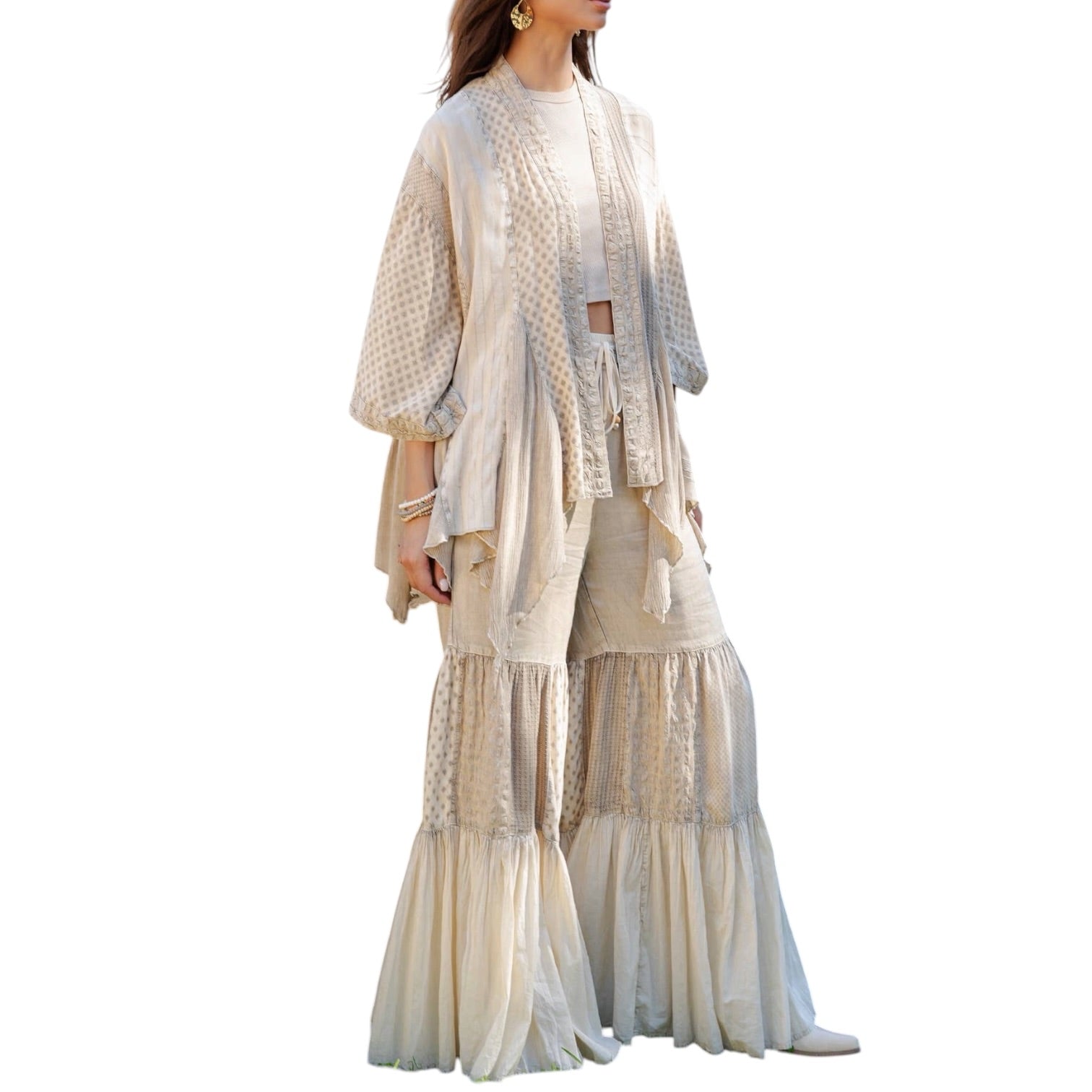 Woman wearing a beige layered outfit on a white background