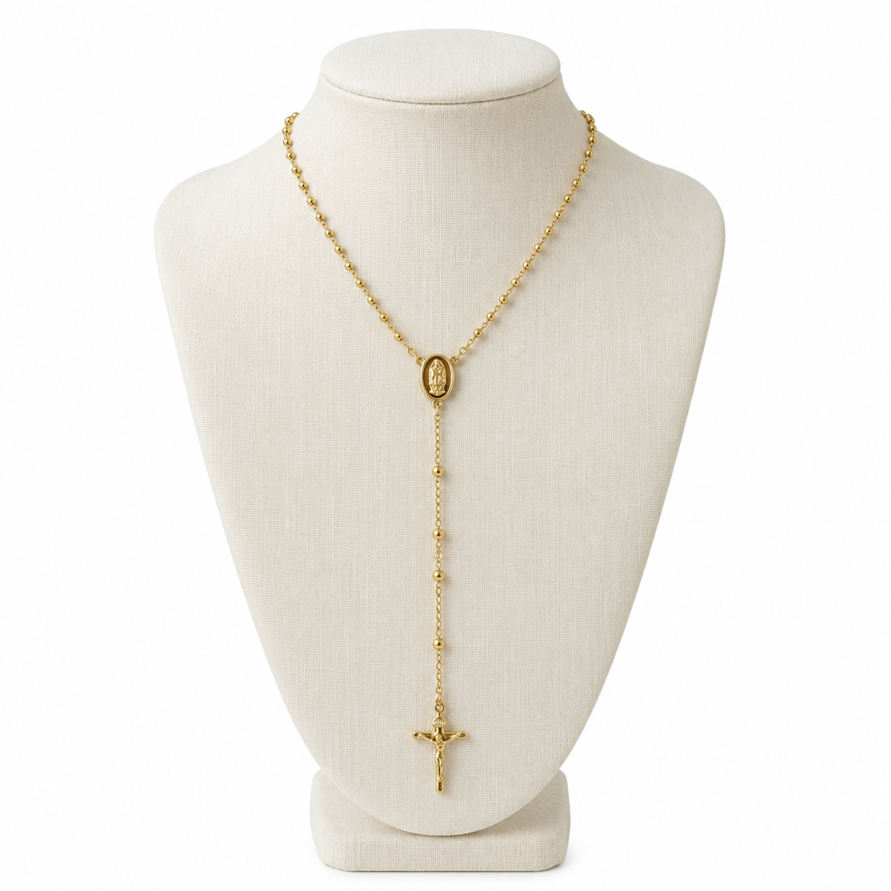 A gold rosary-style necklace displayed on a cream fabric jewelry bust against a white background.
