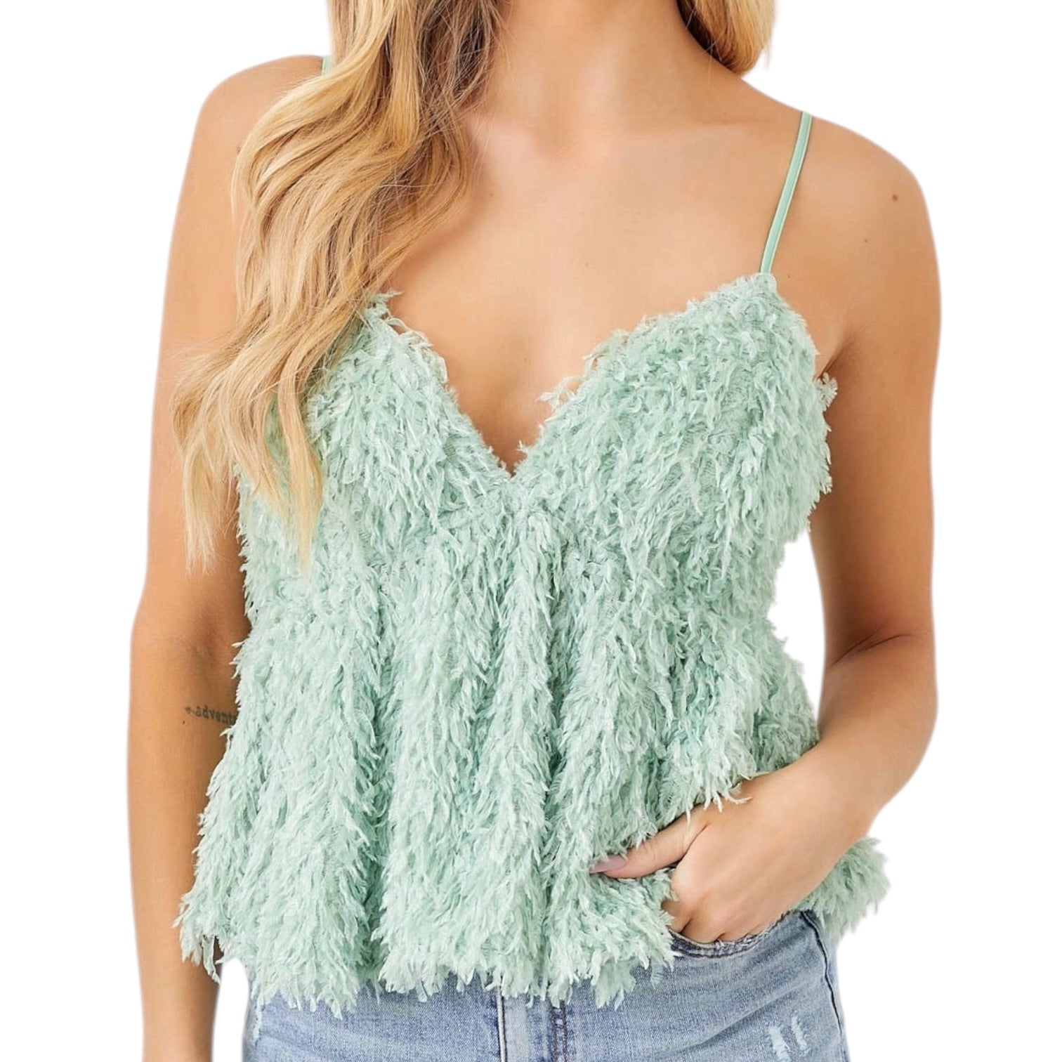 Light green feathered top worn by a person on a white background