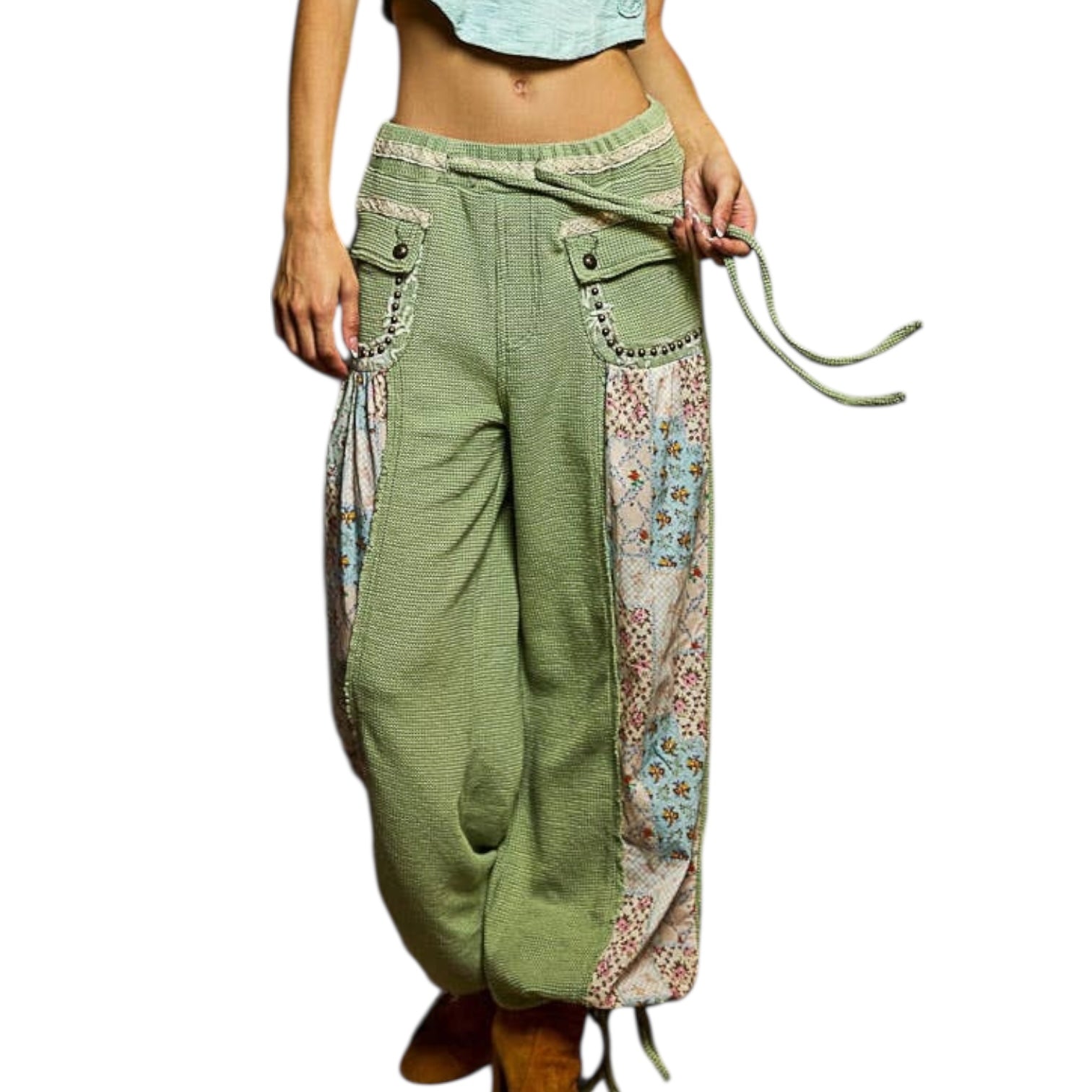 Green patchwork pants with floral patterns on a white background