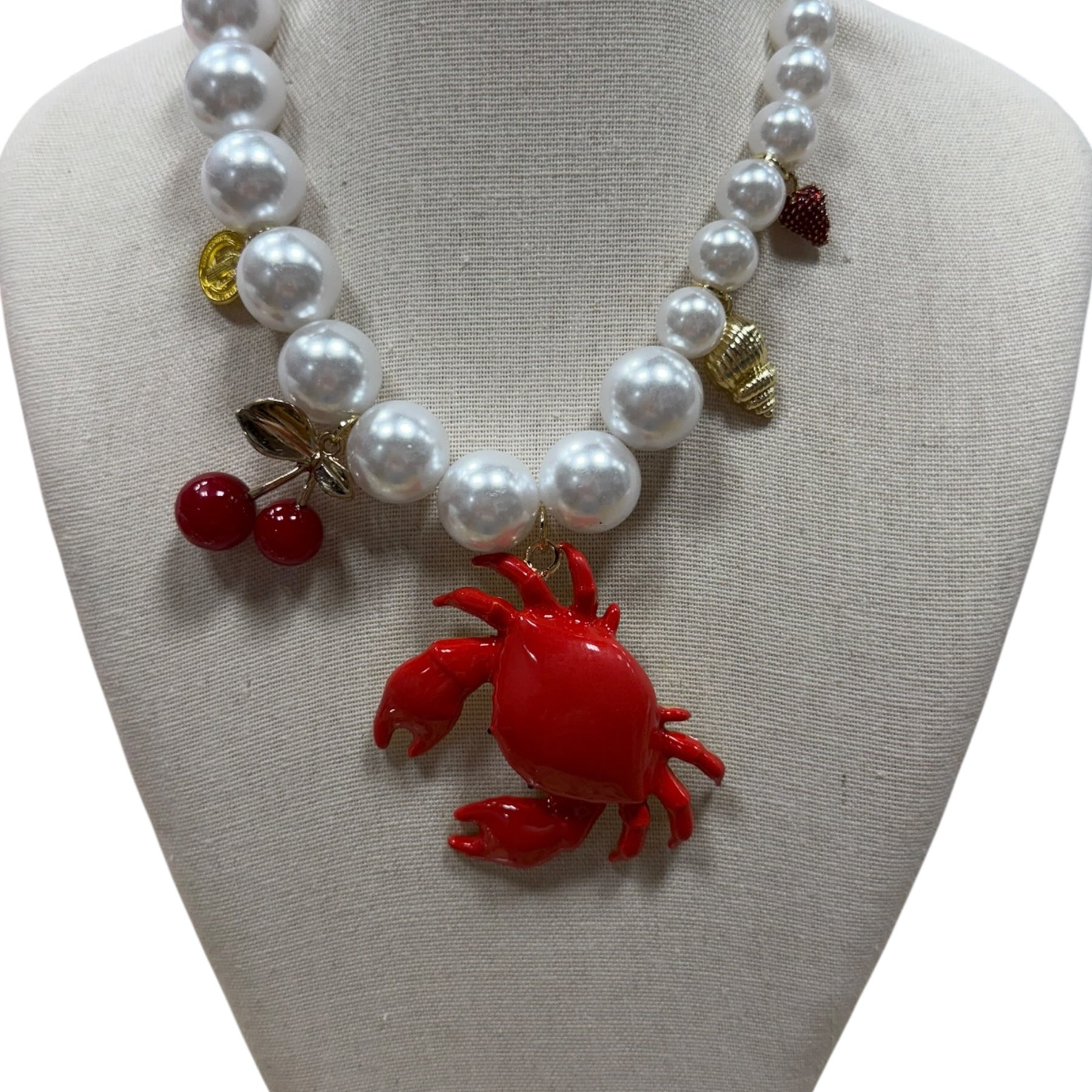 pearl necklace with crab, cherry, strawberry, coin and shell