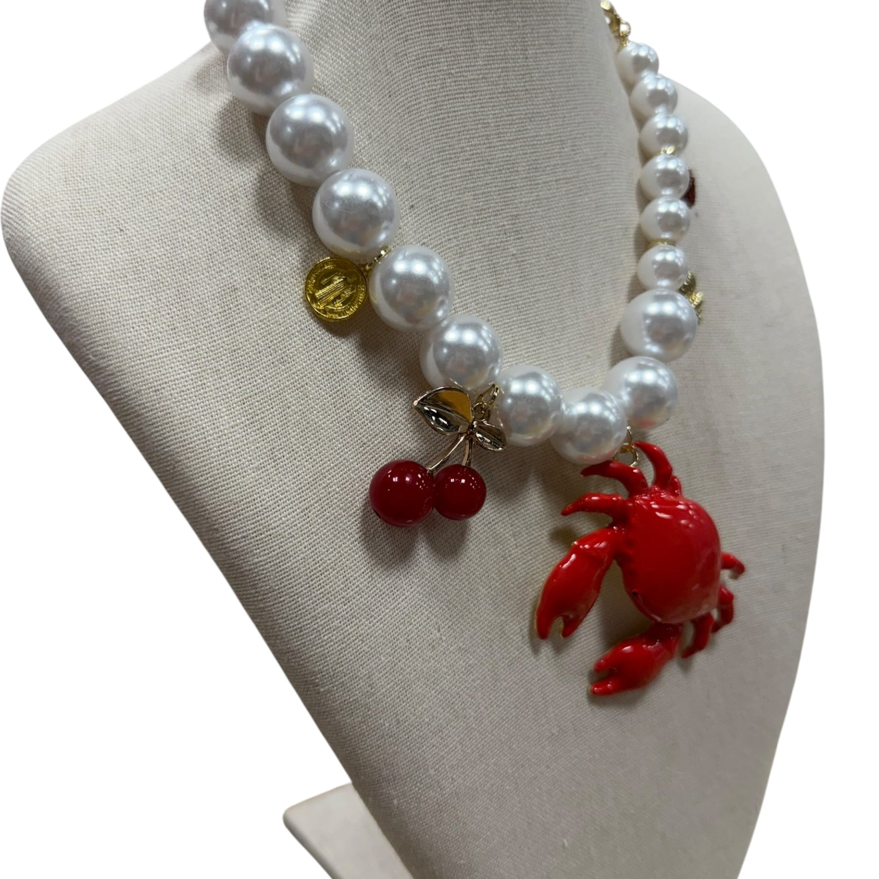 pearl necklace with crab, cherry, strawberry, coin and shell