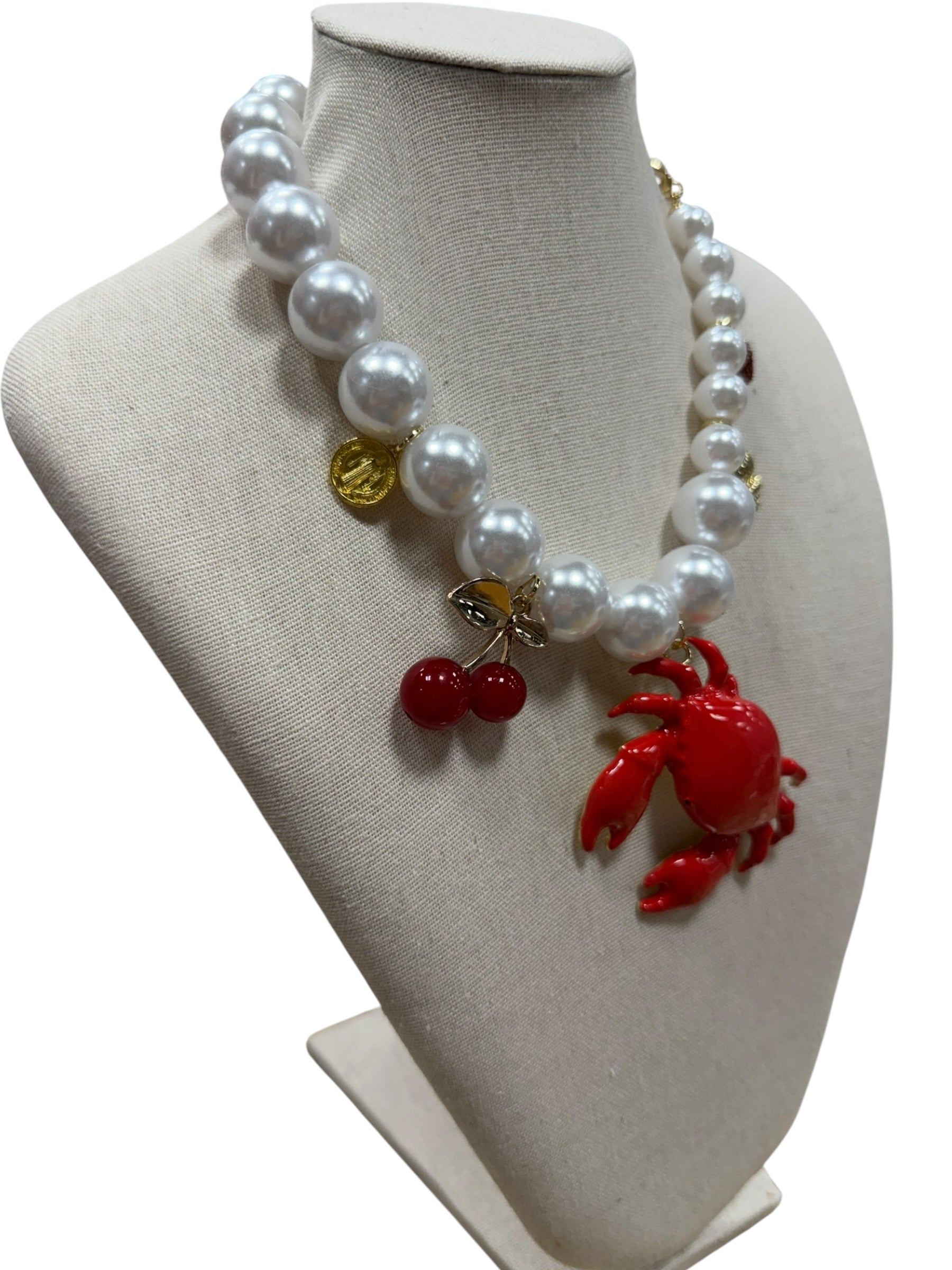 pearl necklace with crab, cherry, strawberry, coin and shell