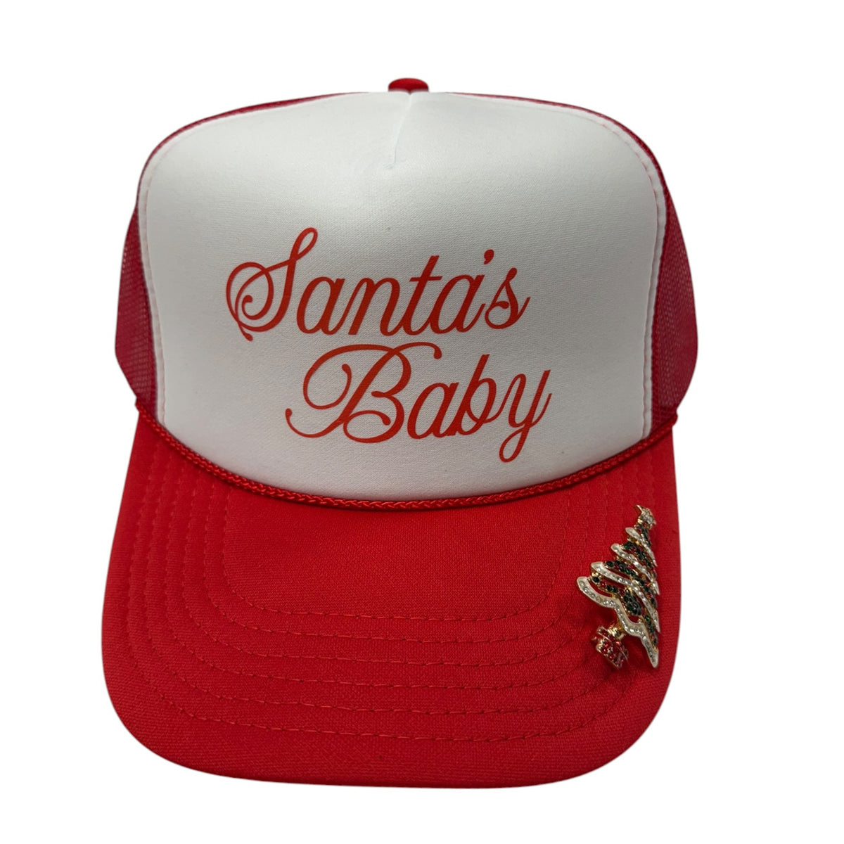 A red and white trucker hat with 'Santa's Baby' embroidered in red on the white front panel and a small gold glittery Christmas tree embellishment on the red brim.