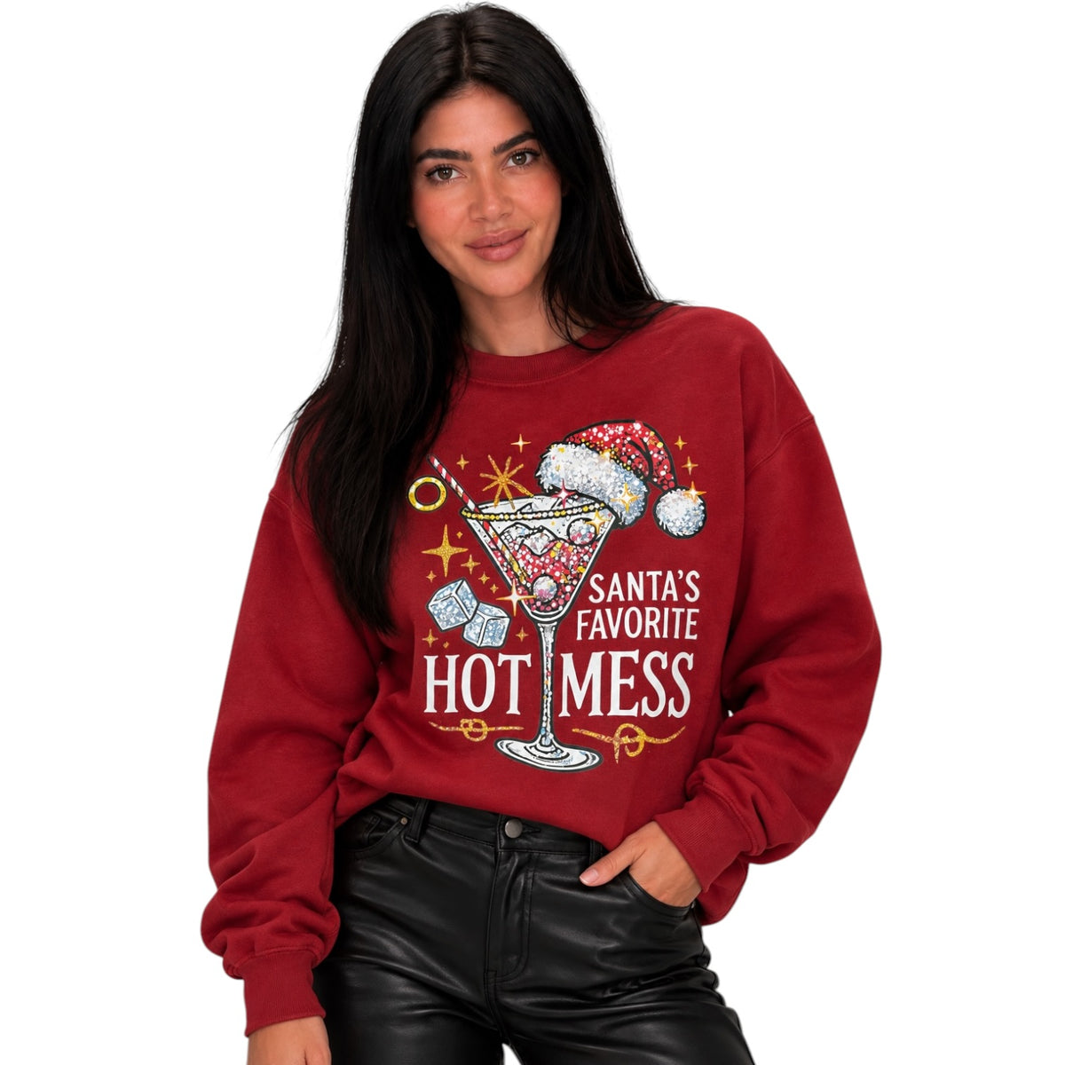 A woman wearing a red crewneck sweatshirt with a graphic of a martini glass, candy canes, and the text 'Santa's Favorite Hot Mess'.