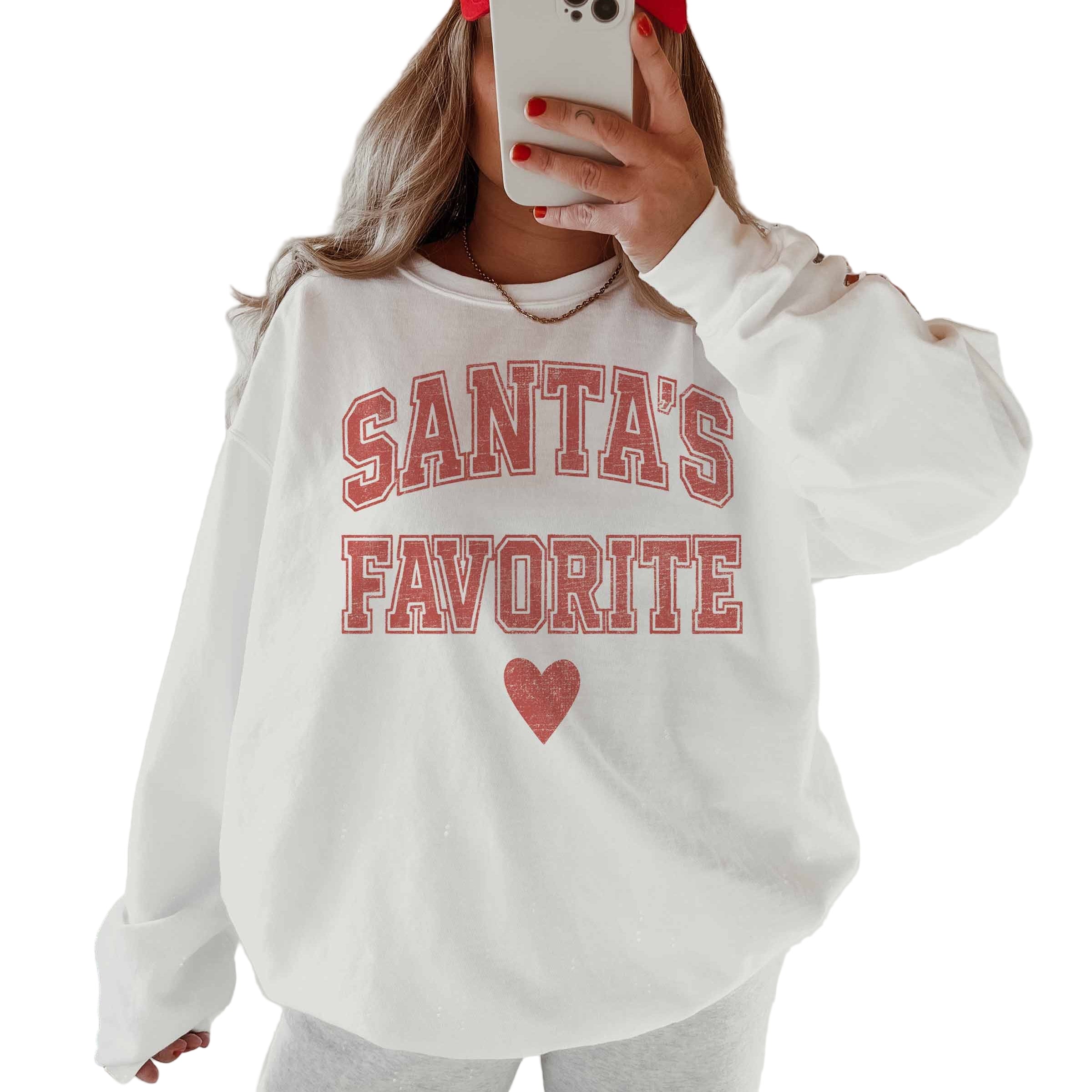 White sweatshirt with 'Santa's Favorite' text and red heart on a white background