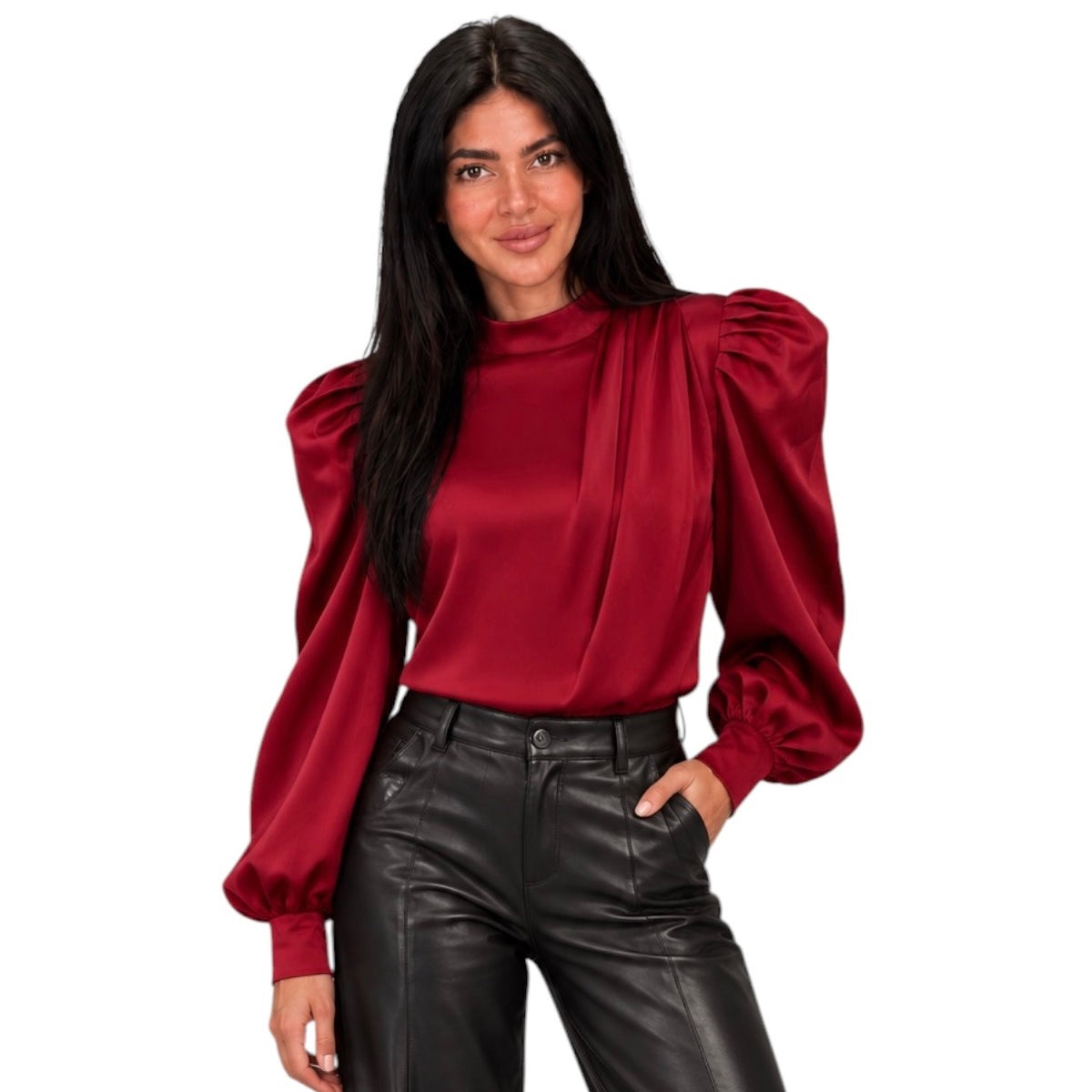 A woman modeling a long-sleeve satin blouse with dramatic puffed balloon sleeves and a gathered neckline, paired with black faux-leather pants, against a plain white background.