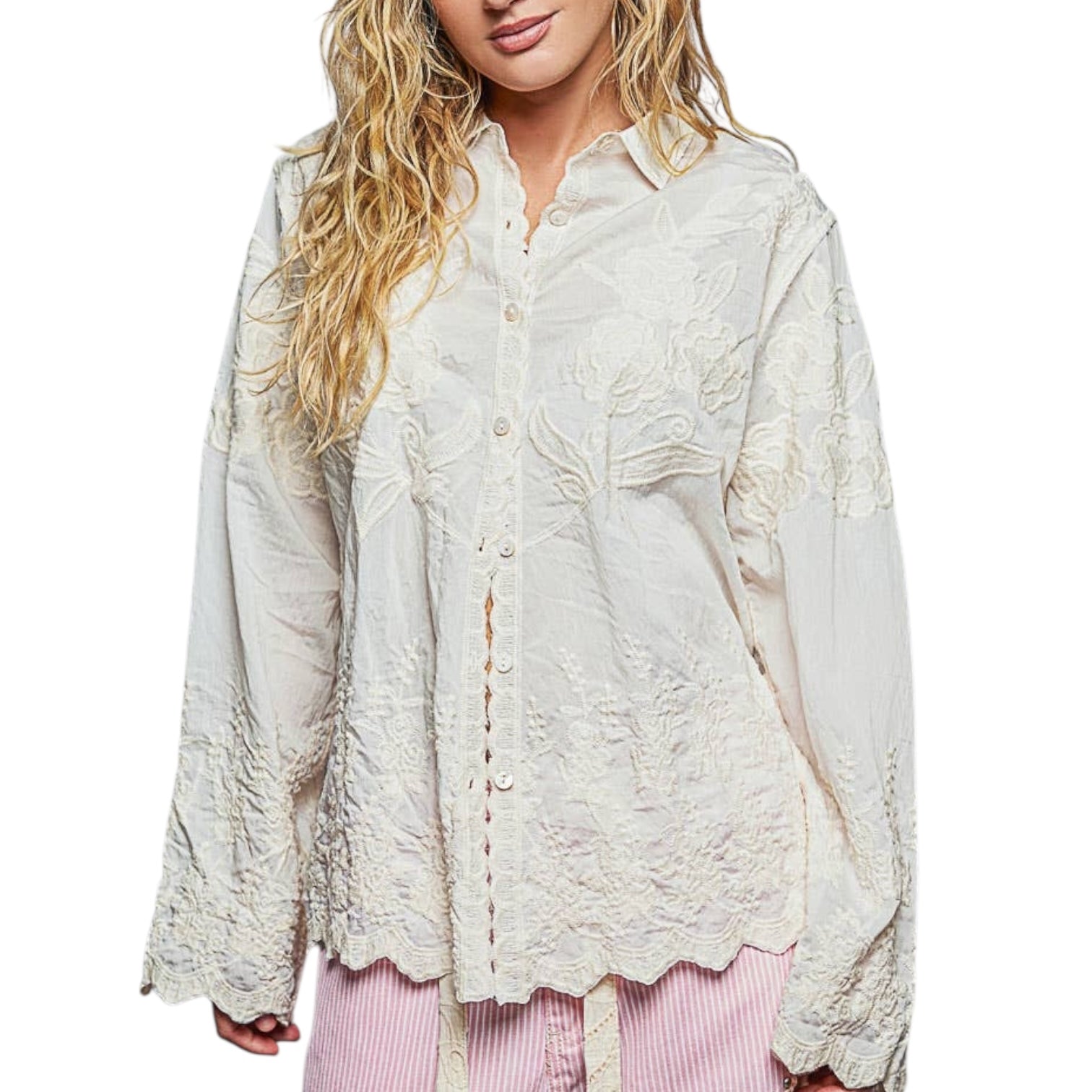 Woman wearing a light-colored lace-up blouse on a white background