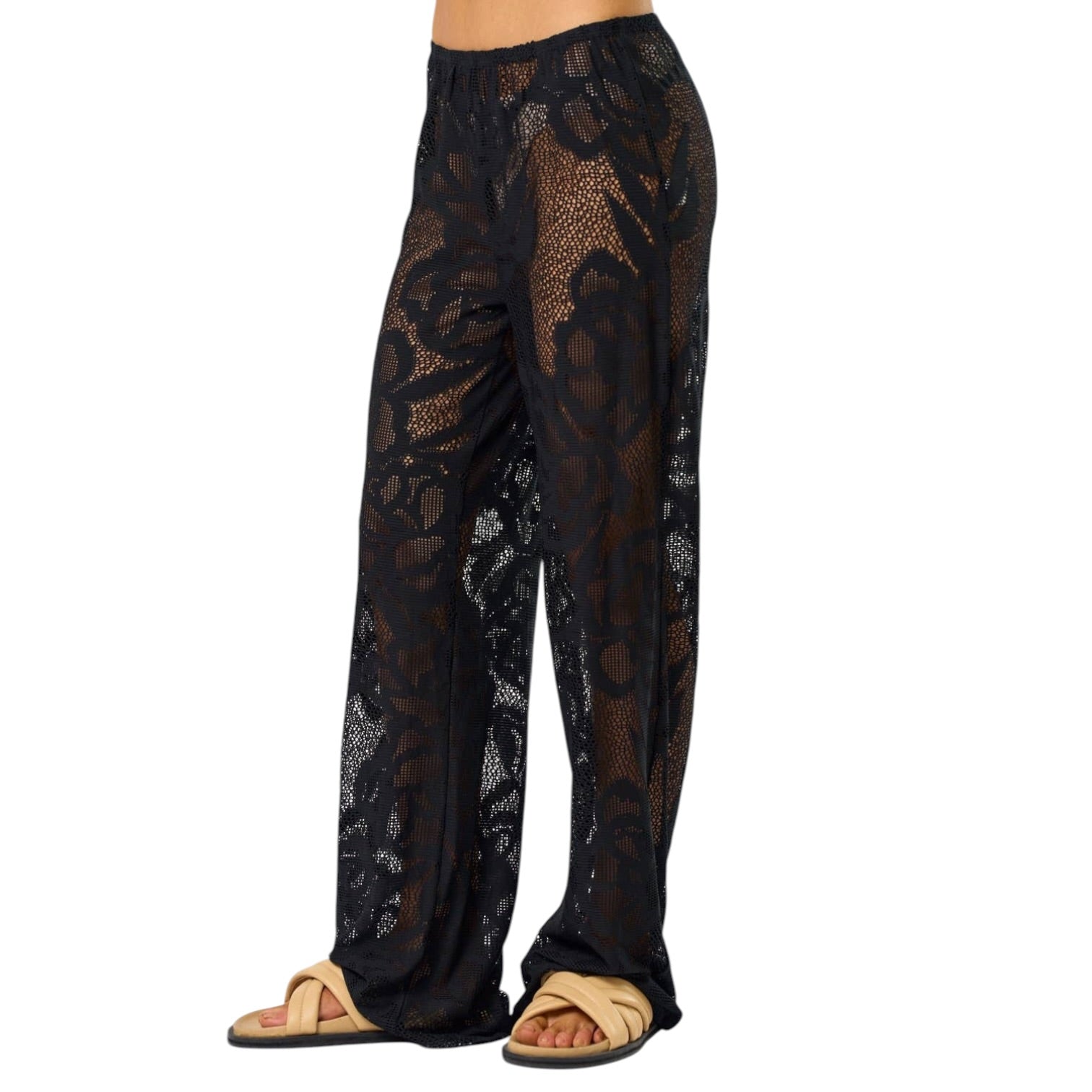 Black lace pants worn by a person on a white background