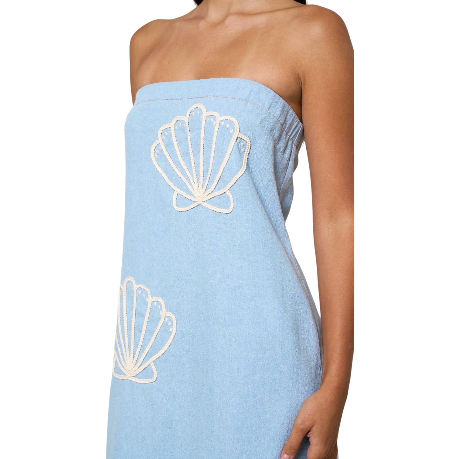 Light blue strapless dress with white shell designs on a white background
