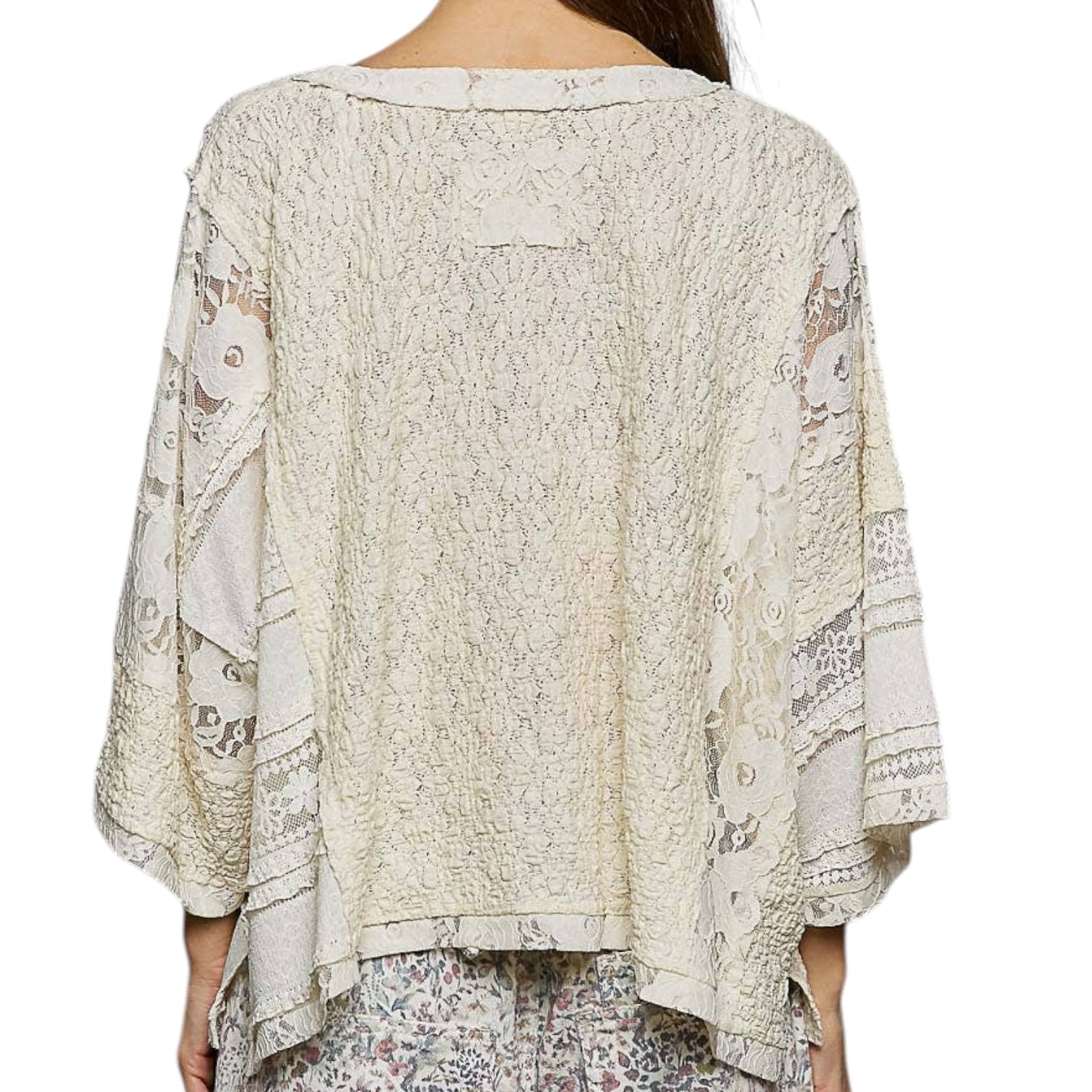 Lace top worn by a person on a white background