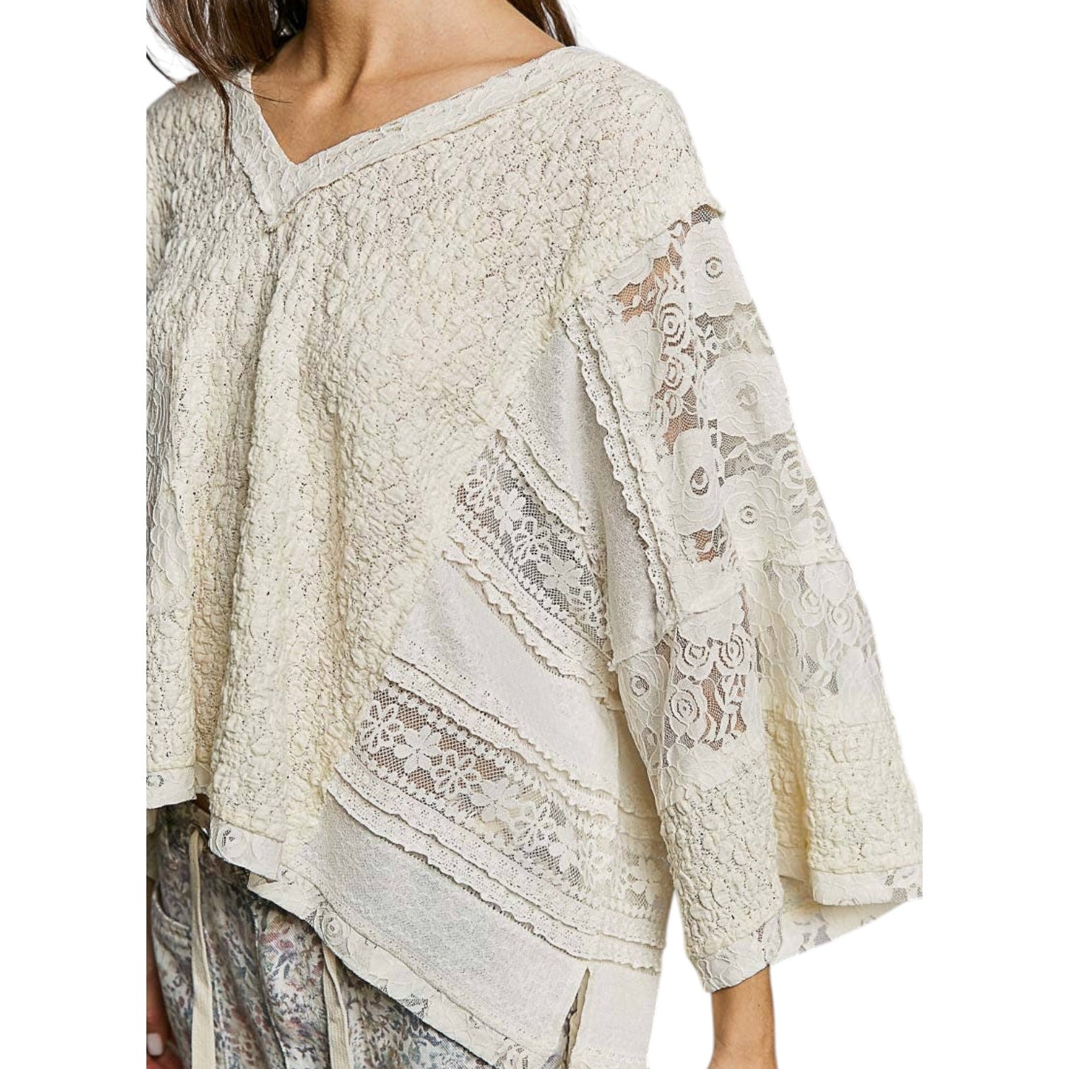 White lace top with intricate patterns on a white background