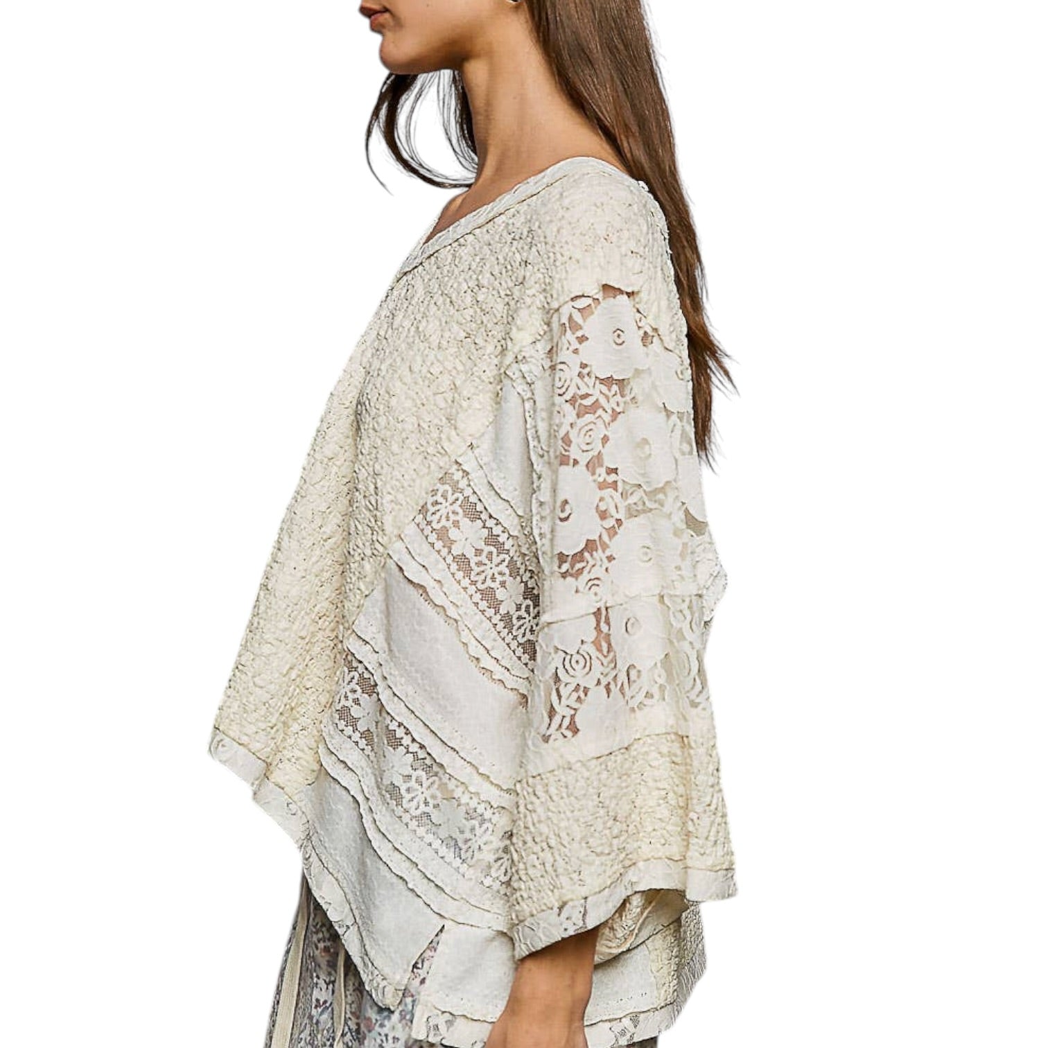 Woman wearing a white lace top on a white background