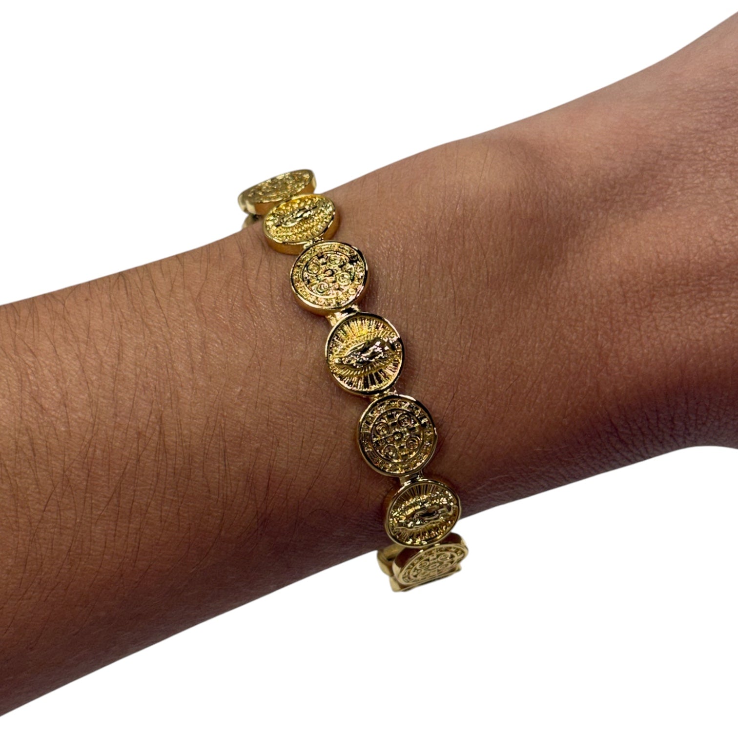 A gold-toned stretch bracelet with five circular, textured coin-like links, shown worn on a person's wrist against a plain white background.