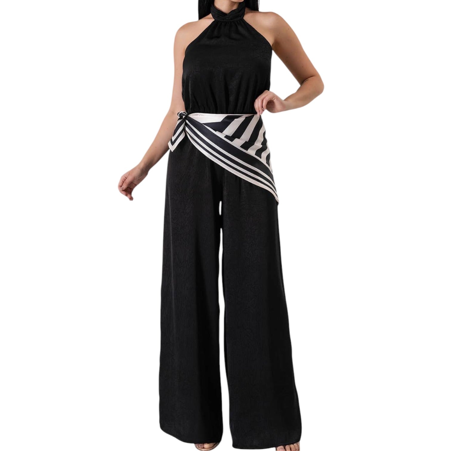 Black halter jumpsuit with a striped sash on a white background