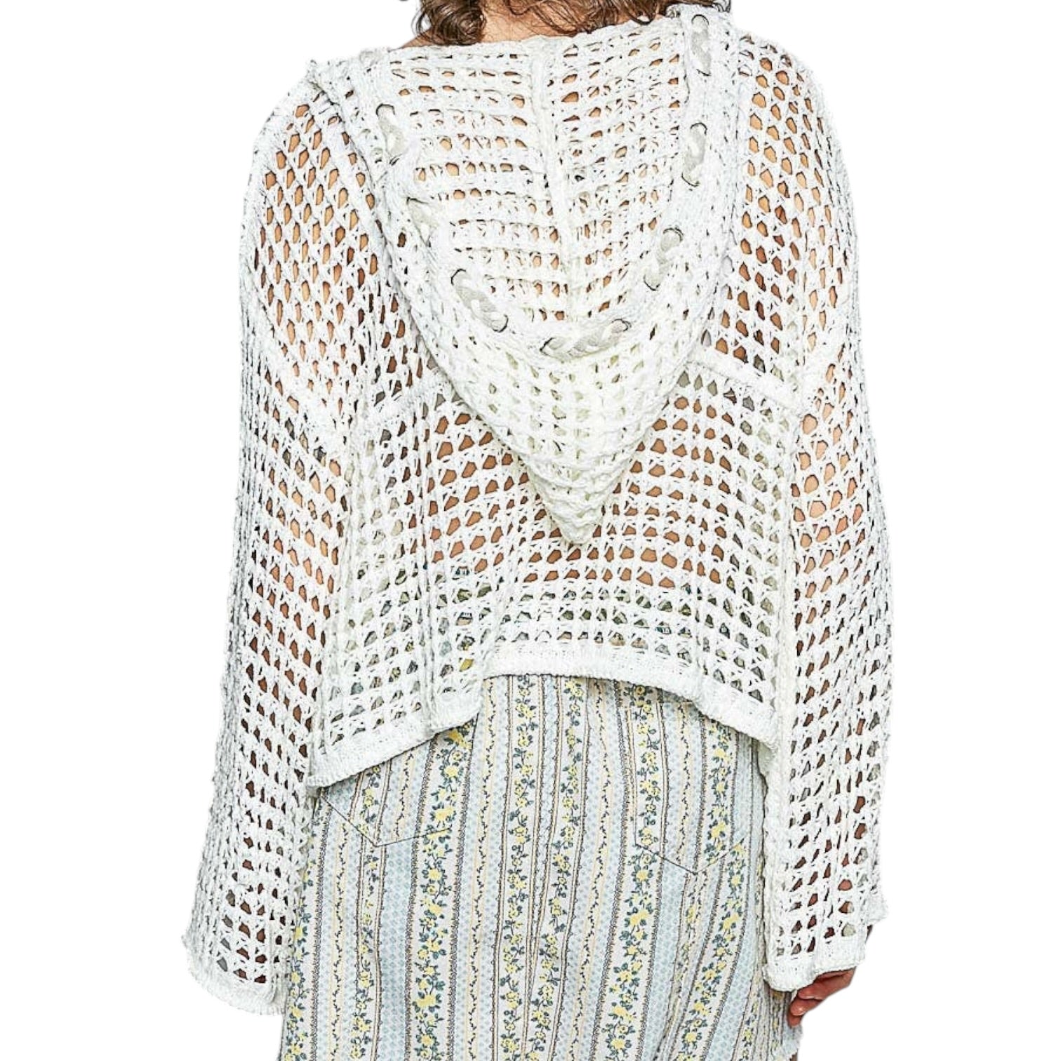 White crochet top worn by a person on a white background