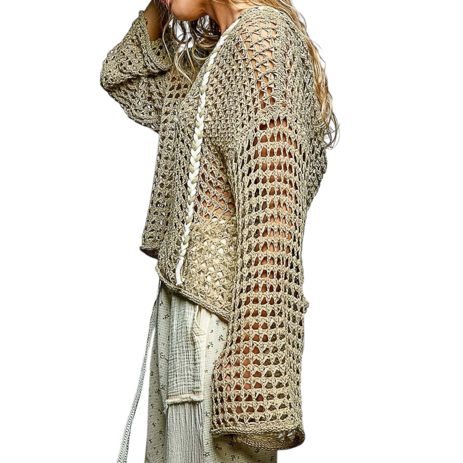 Person wearing a olive crochet cardigan on a white background