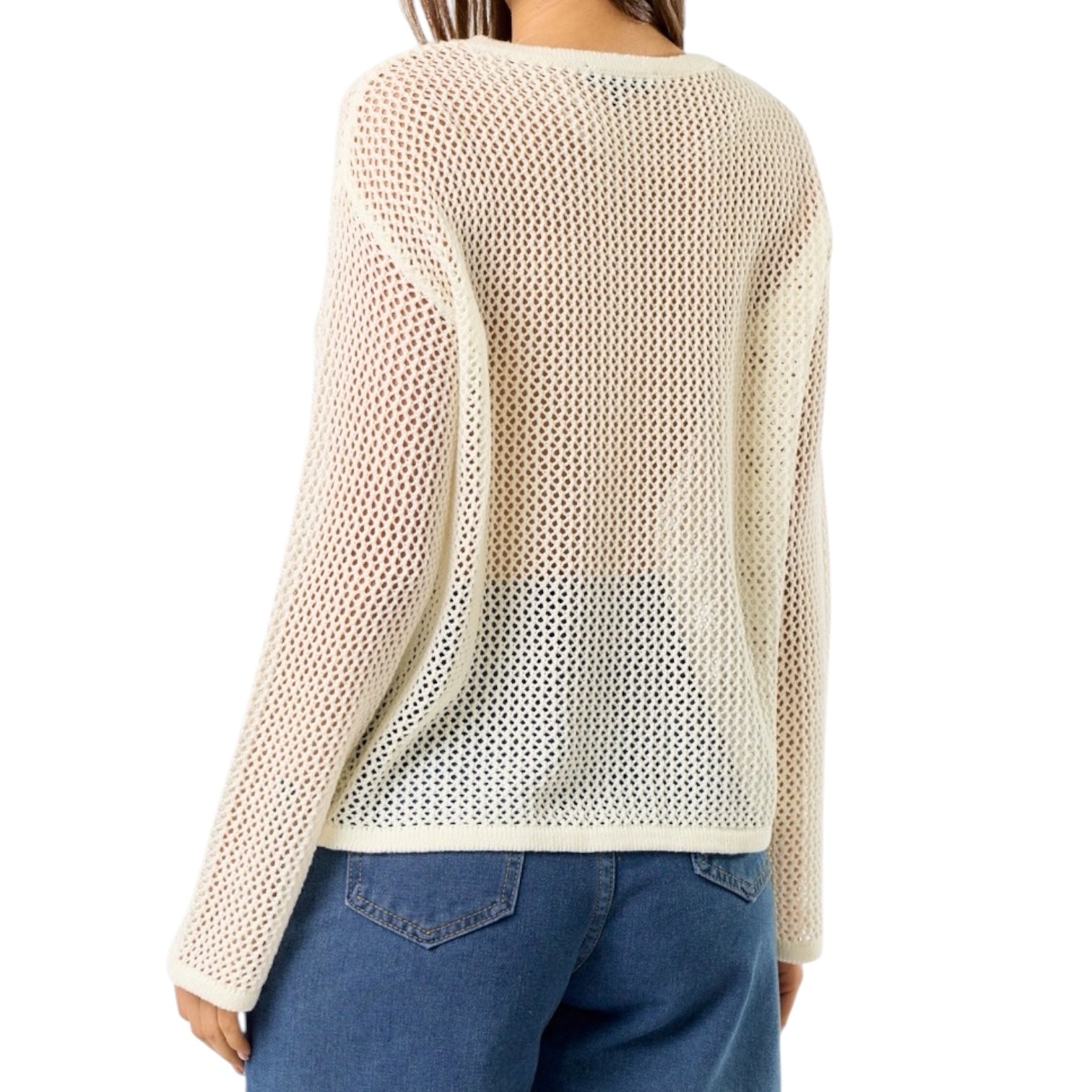 Beige knitted sweater worn by a person on a white background