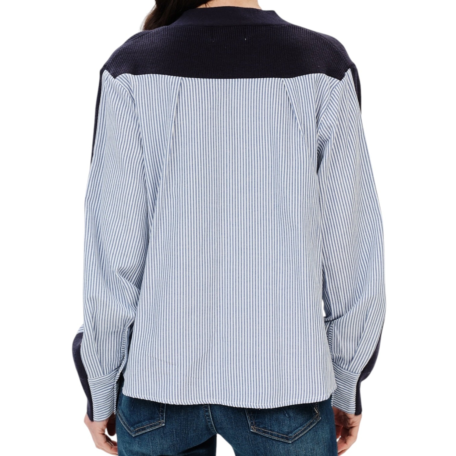 A person shown from the back wearing a long-sleeve button-up shirt with a light blue and white vertical stripe body and contrasting dark navy shoulder yokes and cuffs, paired with blue jeans against a plain white background.