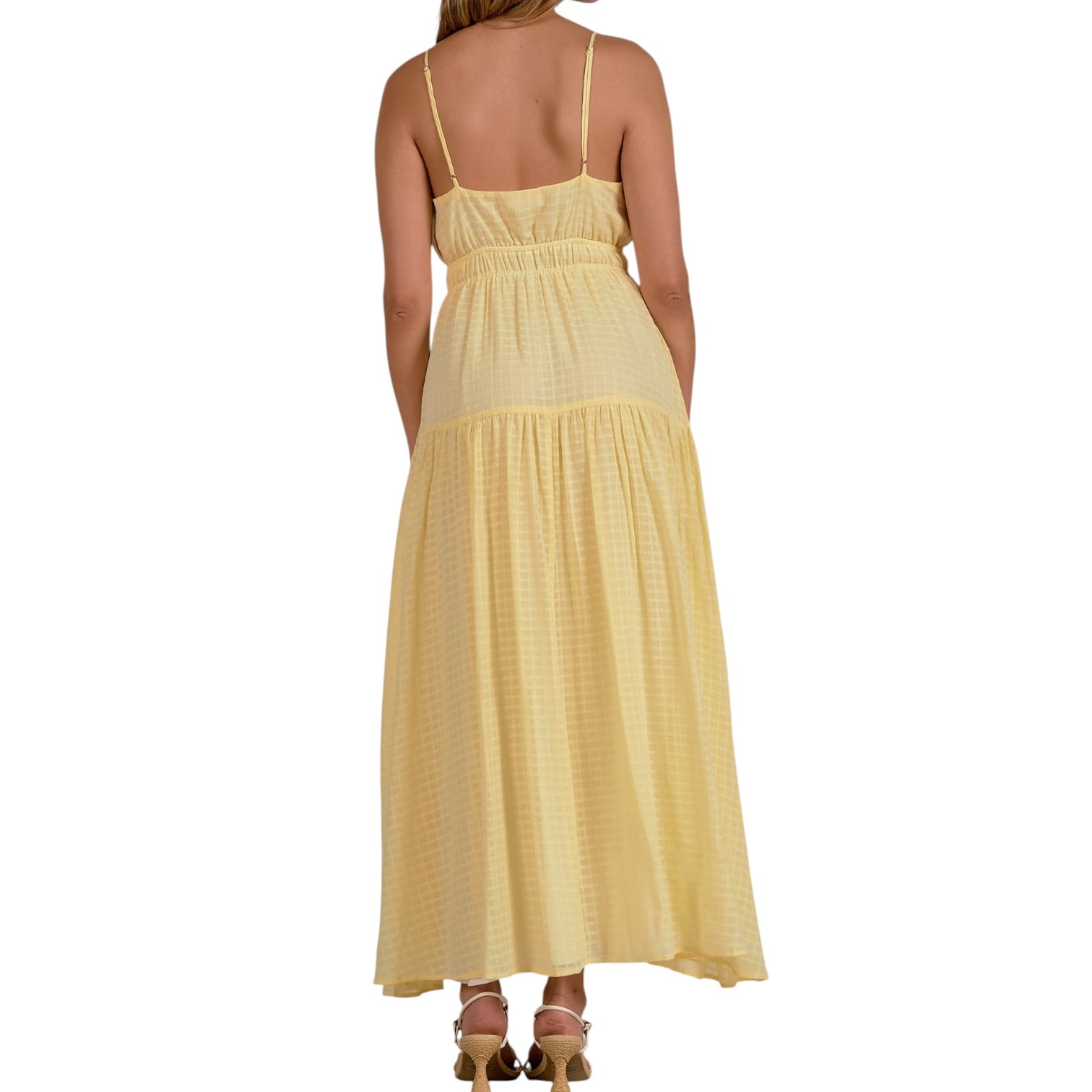 Woman wearing a yellow dress on a white background