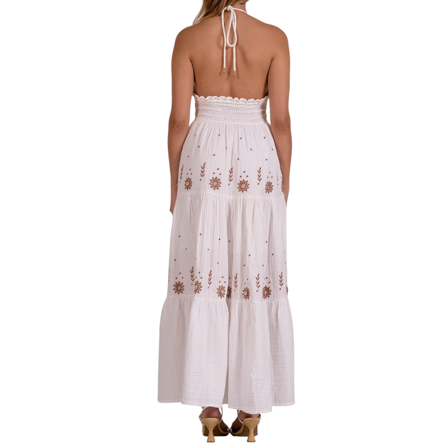 White halter neck dress with floral embroidery on a white background