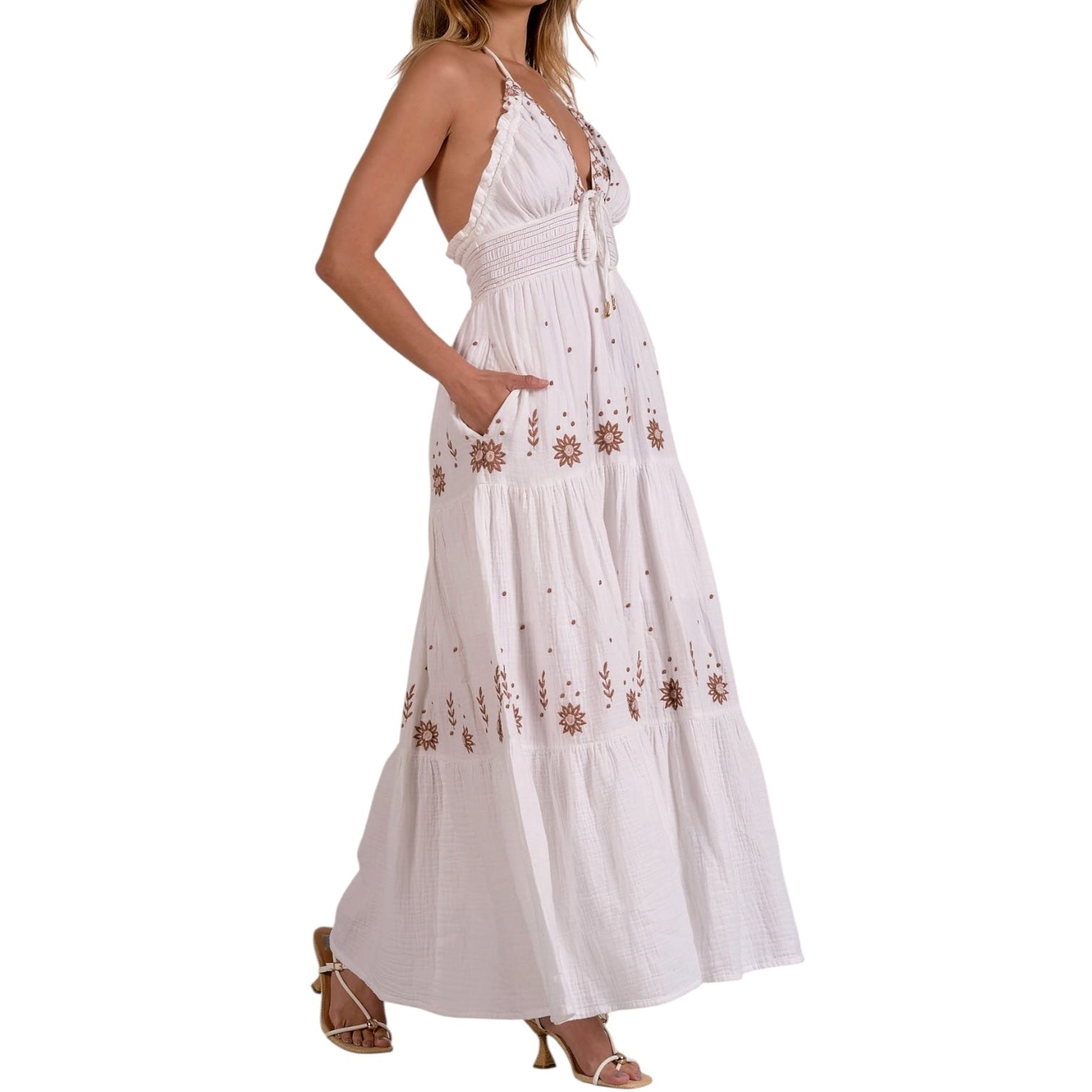 White maxi dress with floral embroidery on a white background