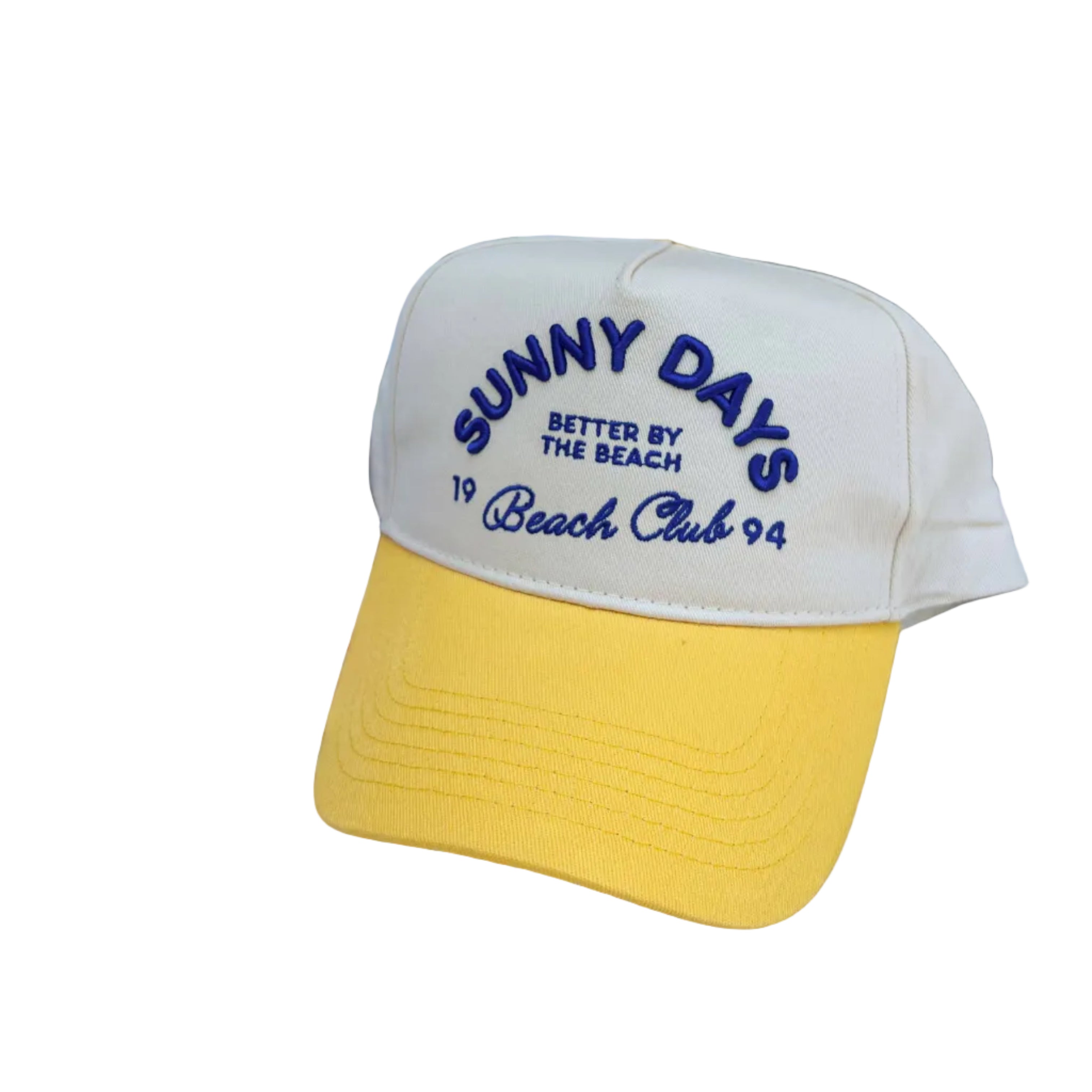 Beige and yellow cap with 'Sunny Days' text, surrounded by colorful bags and items.