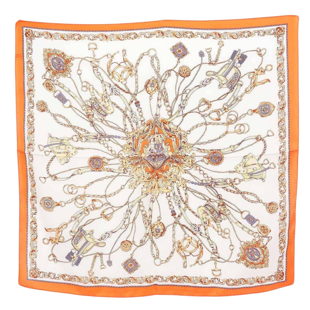 Decorative scarf with intricate patterns and orange border on a white background