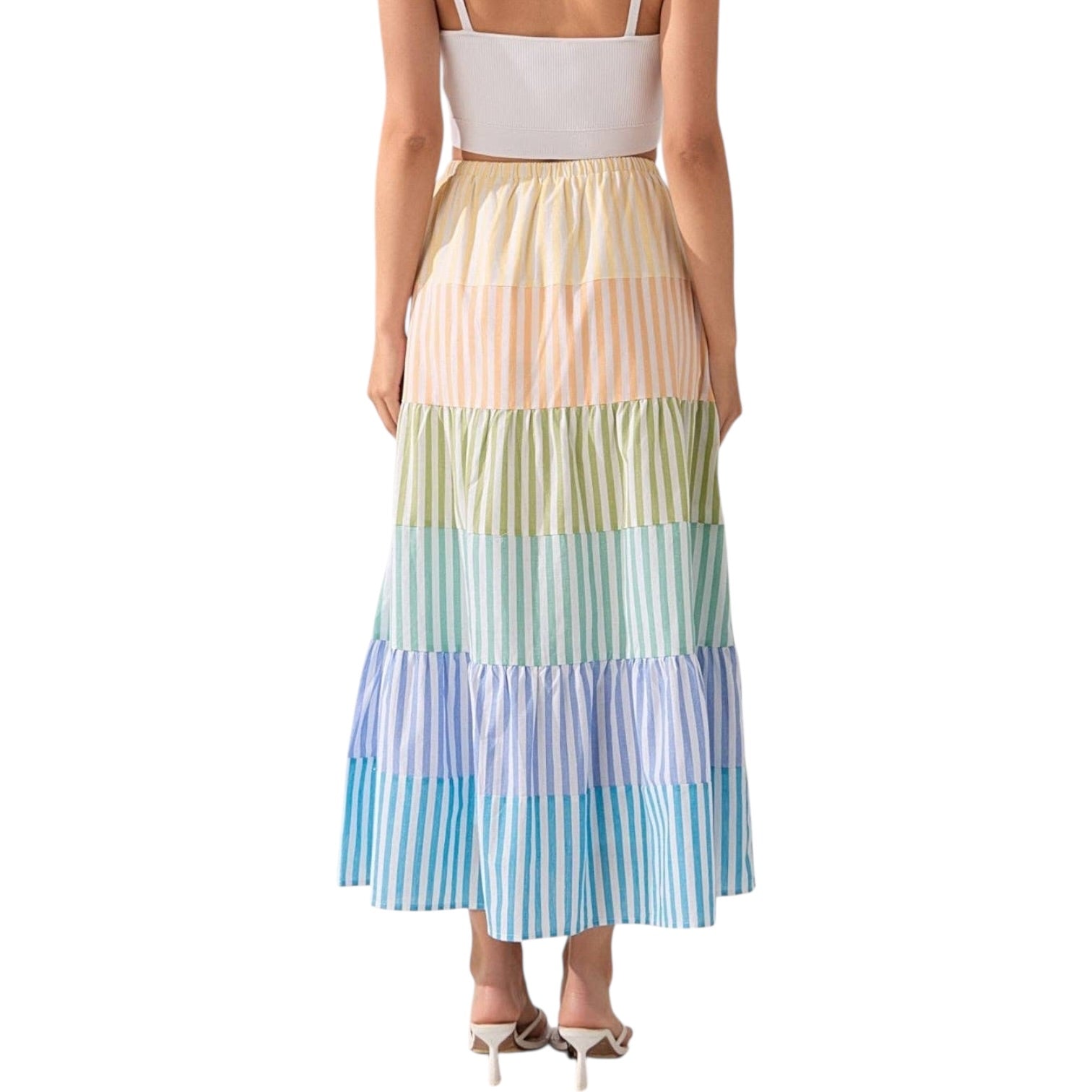 Woman wearing a colorful striped skirt on a white background